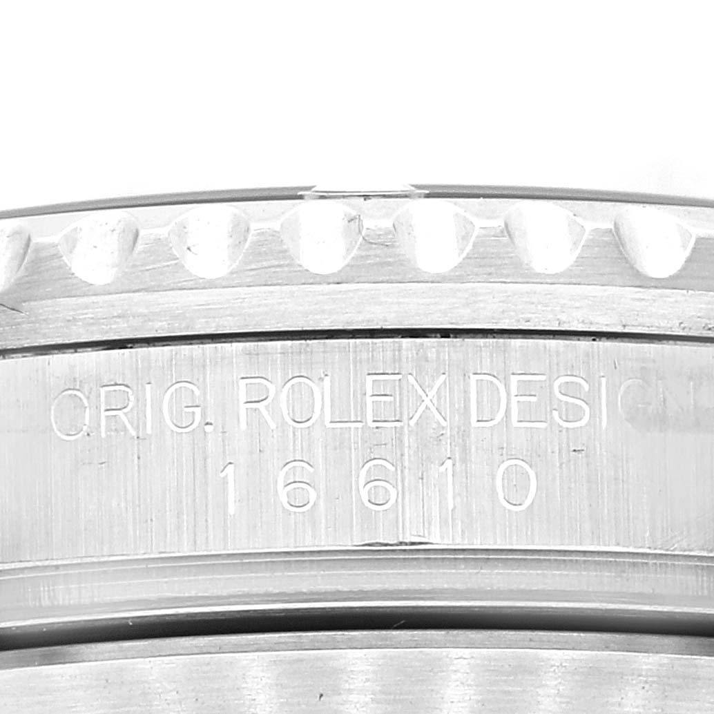 The image shows a close-up angle of the bezel and engraved model number "16610" of a Rolex Submariner 16610 Men
s Stainless Steel Black Dial 16610 Men
s Stainless Steel Black Dial watch.