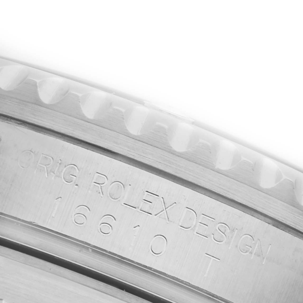 The image shows a close-up of the Rolex Submariner 16610 Men's Stainless Steel Black Dial 16610 Men's Stainless Steel Black Dial's engraved case side and bezel teeth from a side angle.