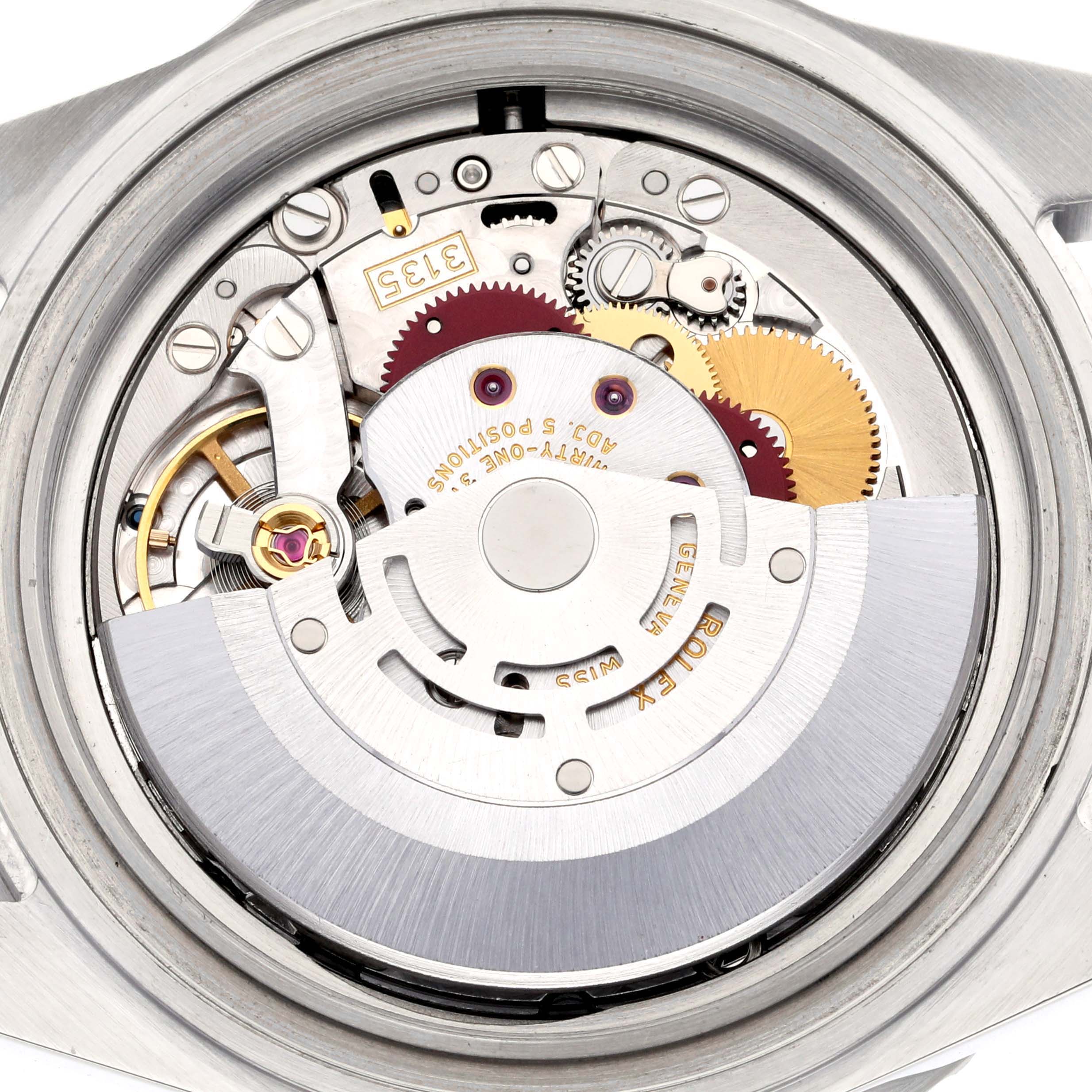The image shows the movement of a Rolex Submariner 16610 Men's Stainless Steel Black Dial 16610 Men's Stainless Steel Black Dial watch, viewed from the back, highlighting the rotor and intricate gears.