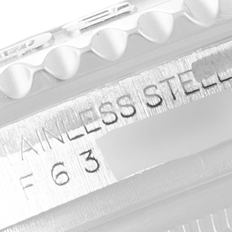 The image shows an angled close-up of the Yacht-Master Rolex watch's bezel and case, highlighting the "STAINLESS STEEL" engraving.