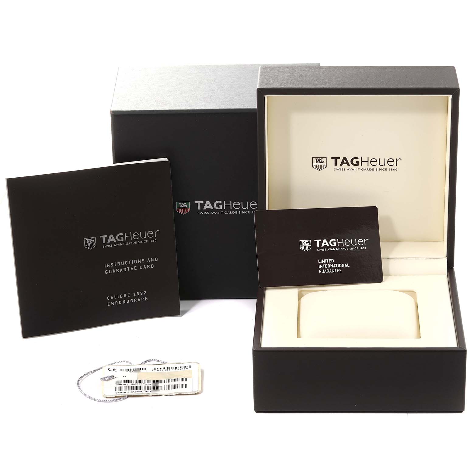 The image shows the Tag Heuer Carrera CAR2A11.BA0799 Men's Stainless Steel Grey Dial CAR2A11.BA0799 Men's Stainless Steel Grey Dial watch box, instructions manual, guarantee card, and tag from a front angle.