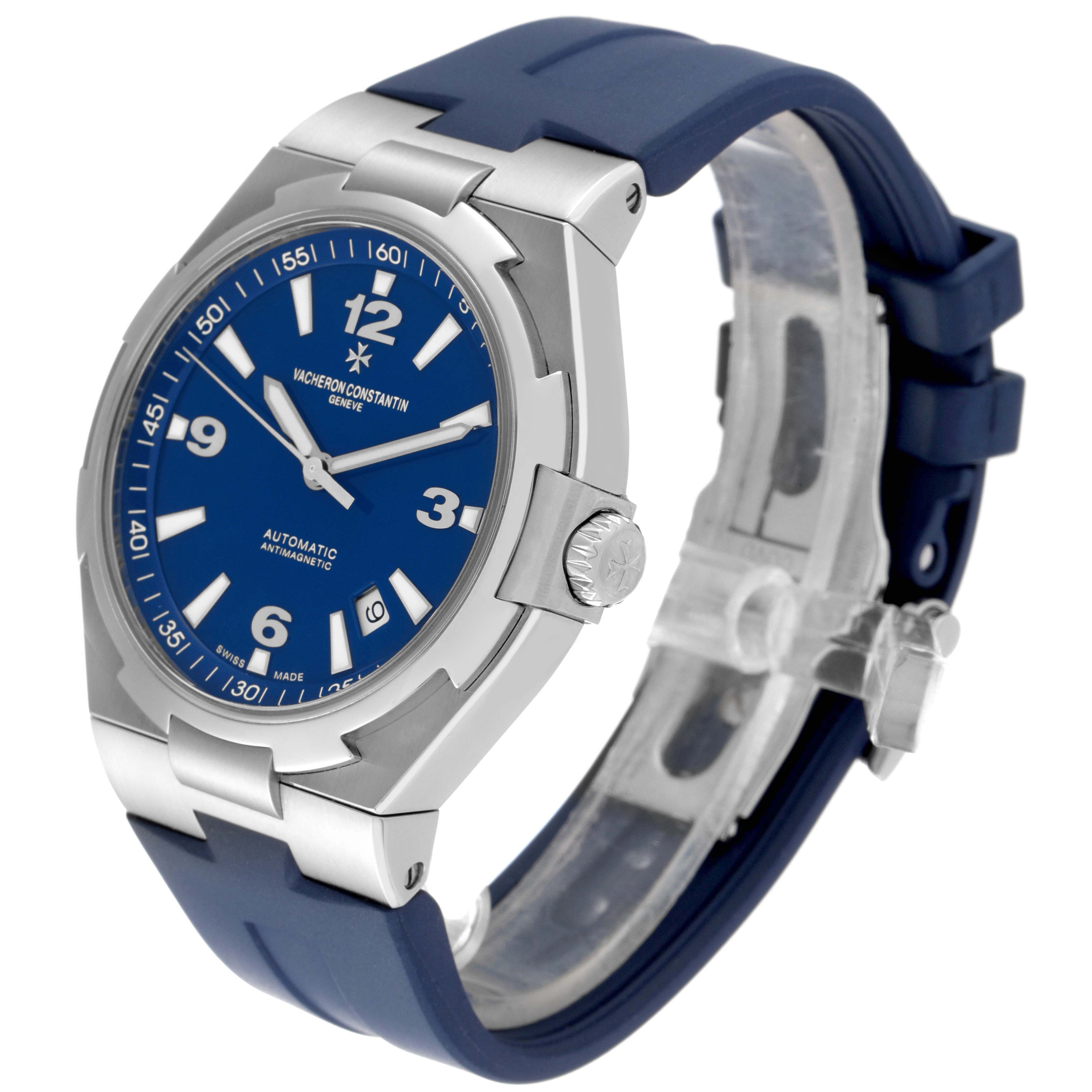 The Vacheron Constantin Overseas 47040/000A-9008 Men's Stainless Steel Blue Dial watch is shown from an angled side view, highlighting the blue dial, case, crown, and strap.