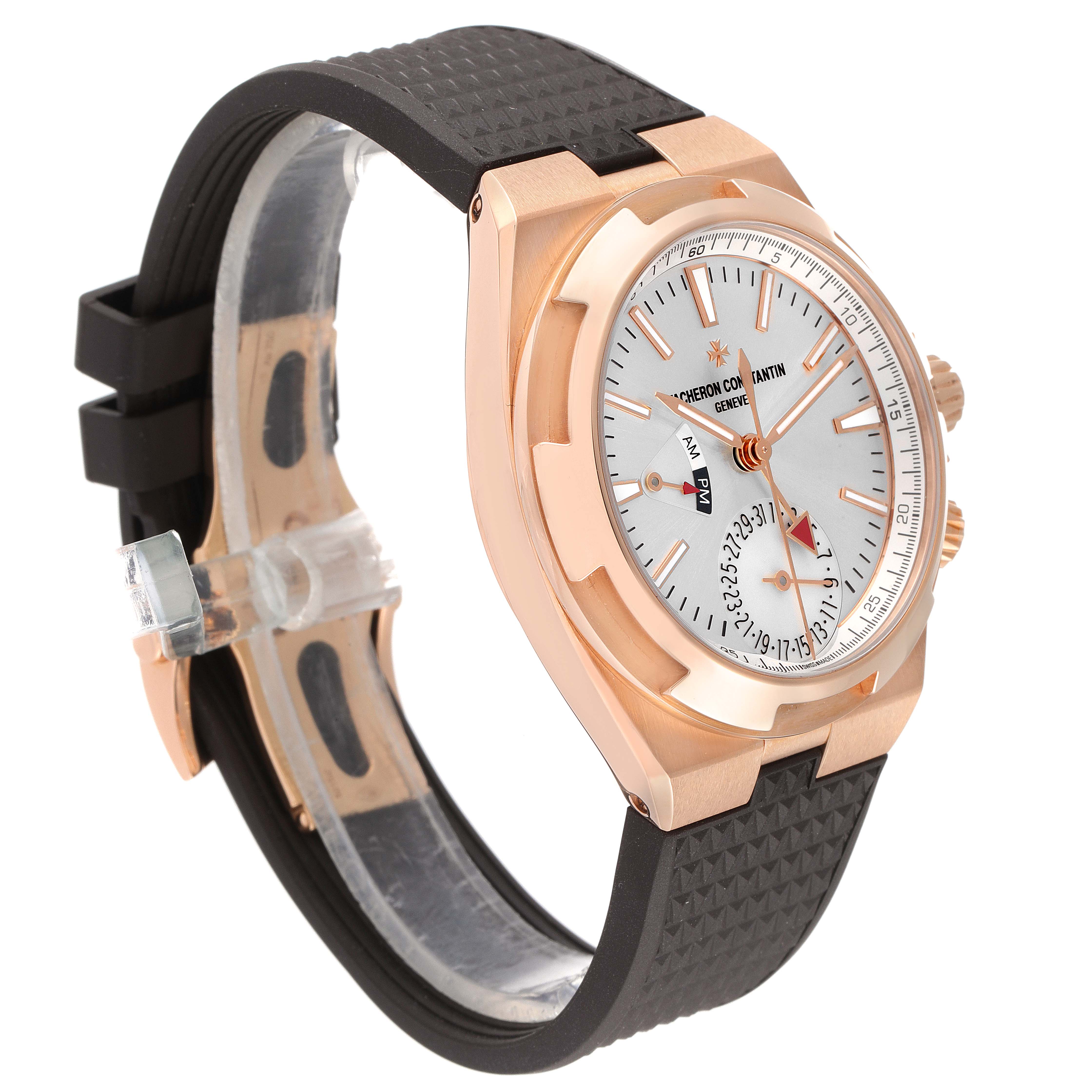 The Vacheron Constantin Overseas 7900V/000R-B336 Men's Rose Gold Silver Dial 7900V/000R-B336 Men's Rose Gold Silver Dial watch is shown at an angled side view, displaying its rose gold case, dial, and black rubber strap.