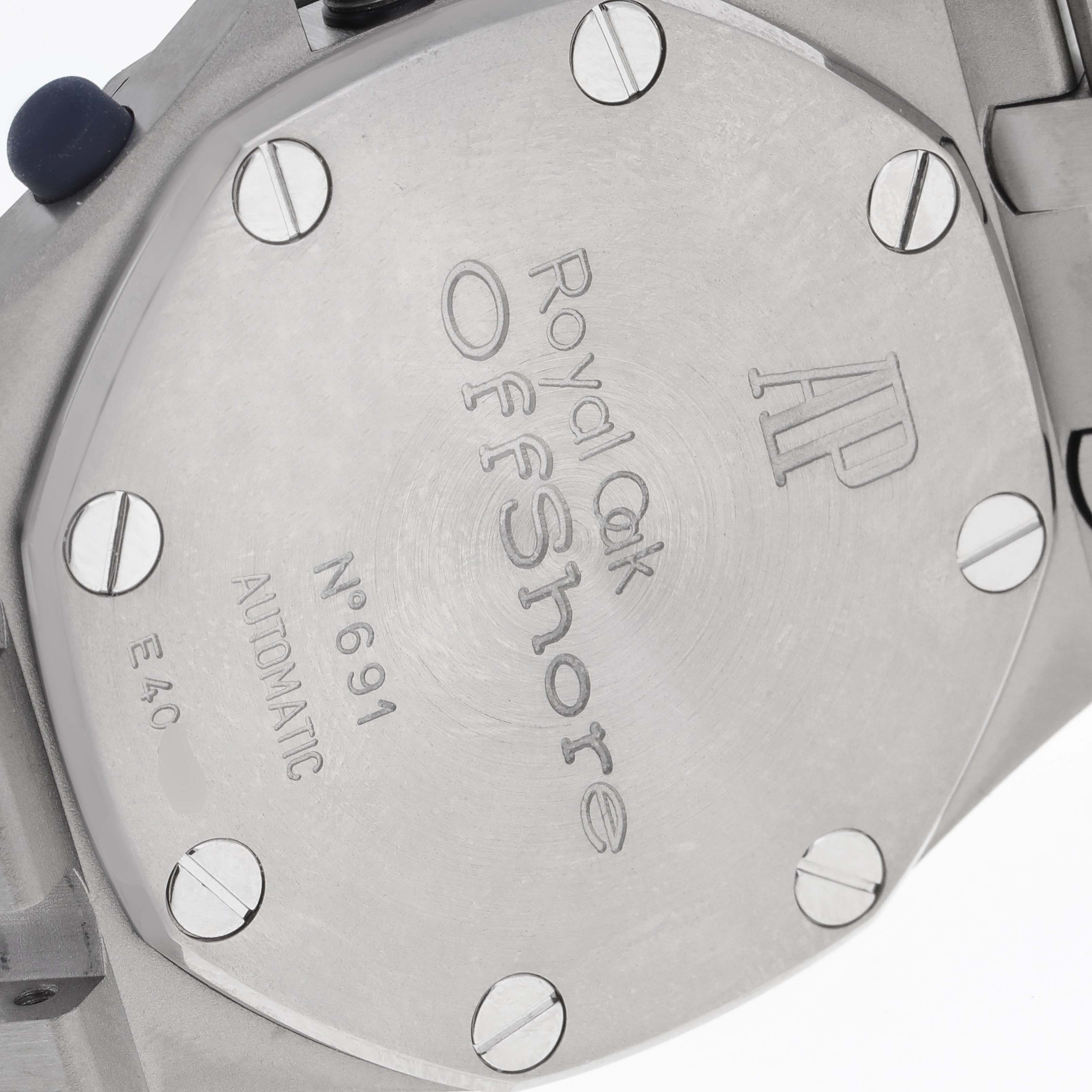 The image shows the back case of a Royal Oak Offshore watch by Audemars Piguet, detailing its screws and engravings.