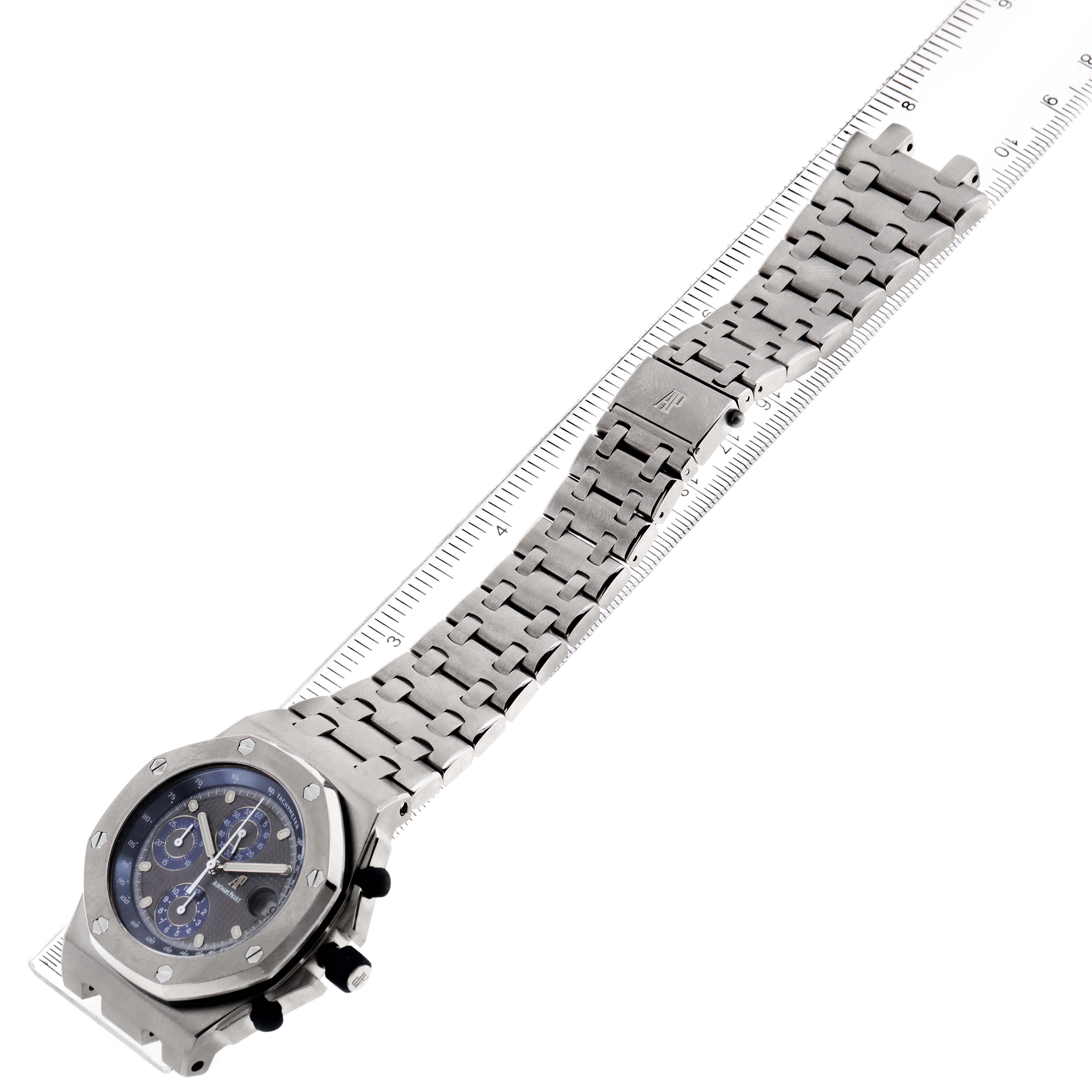 The image shows an Audemars Piguet Royal Oak Offshore 25721TI  Men's Titanium Grey Dial 25721TI  Men's Titanium Grey Dial watch with a metal bracelet, viewed from a top-down angle.