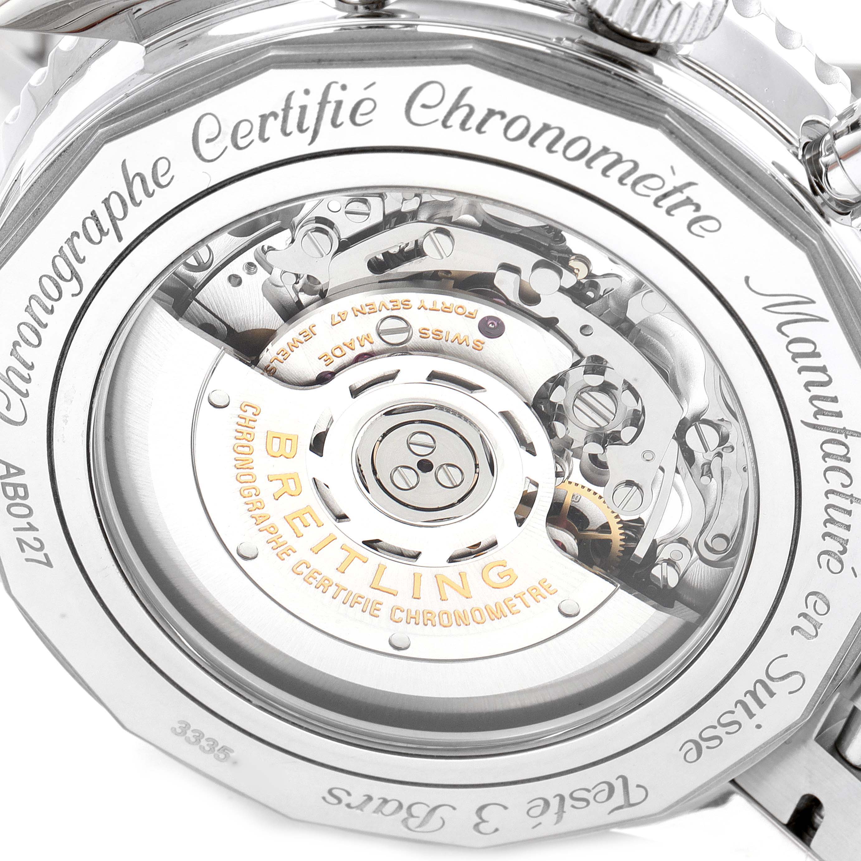 The image shows the back view of a Breitling Navitimer AB0127211C1A1 Men's Stainless Steel Blue Dial AB0127211C1A1 Men's Stainless Steel Blue Dial watch, highlighting its intricate mechanical movement and engravings.