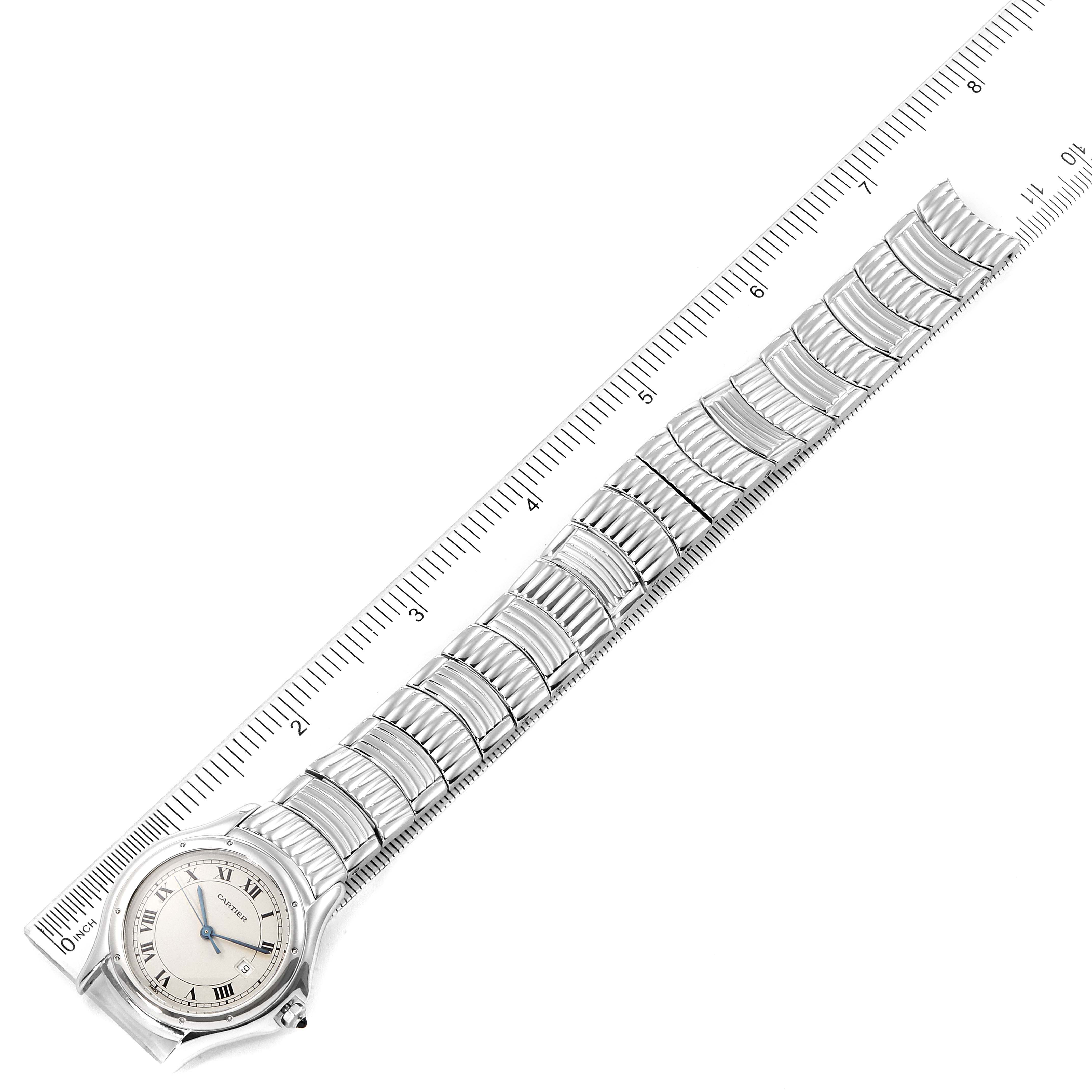 The image shows the full front view of the Cartier Santos W20027K1 Men
s Stainless Steel Silver Dial W20027K1 Men
s Stainless Steel Silver Dial model watch lying flat next to a ruler.