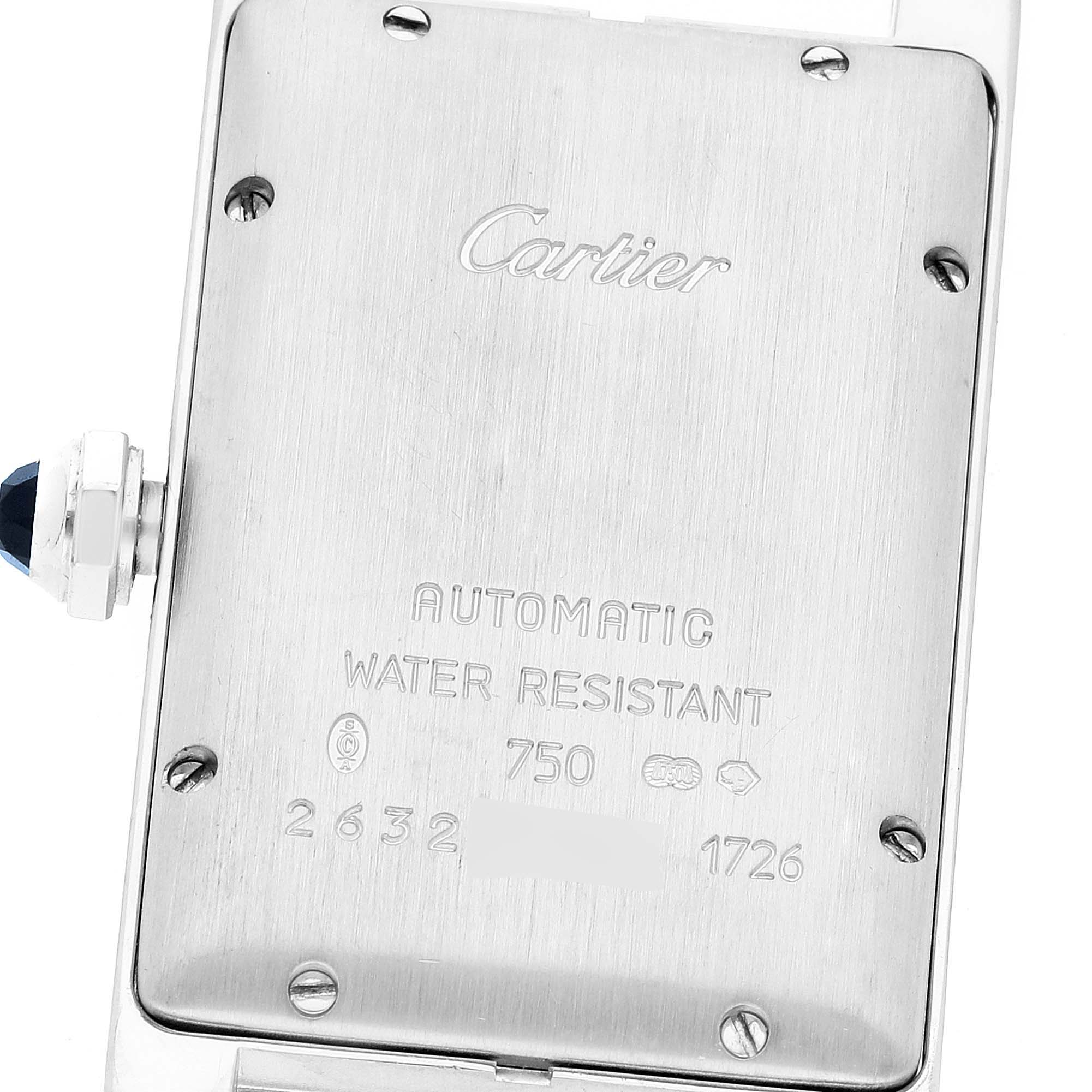 The image shows the back case of the Cartier Tank Americaine W2603656 Women
s White Gold Silver Dial W2603656 Women
s White Gold Silver Dial watch, highlighting its brand, water resistance, and automatic movement.