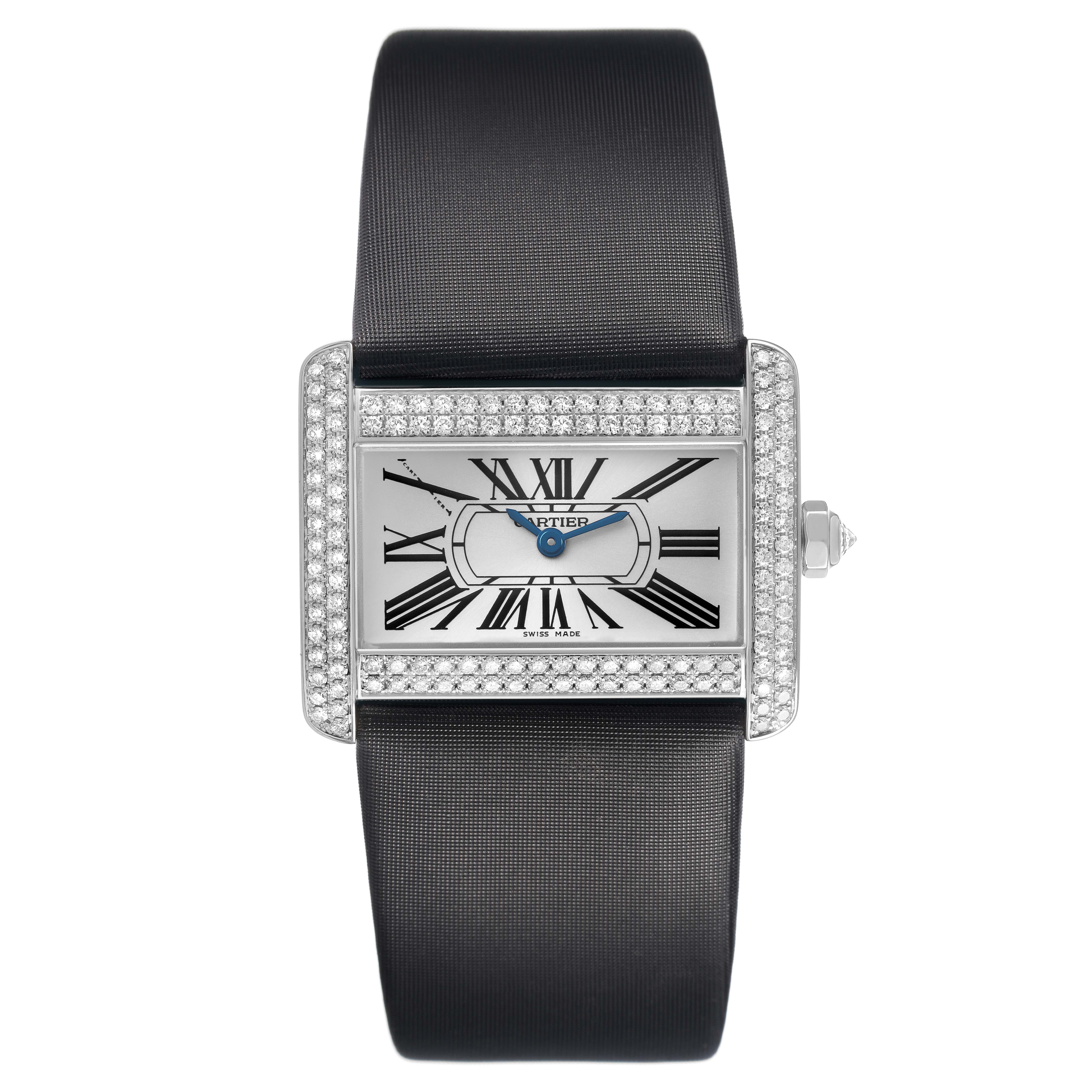 The Cartier Tank Divan WA301271 Women's White Gold Silver Dial watch is shown from a top-down angle, highlighting its rectangular face, Roman numerals, diamond-set bezel, and black strap.