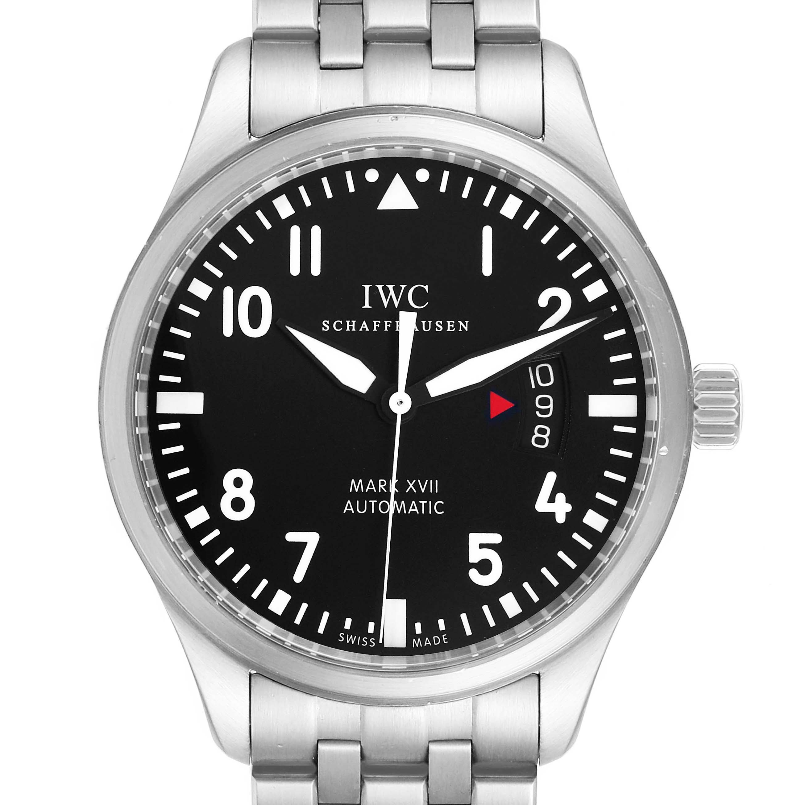 The Pilot model by IWC is shown from a front angle, displaying the dial, bezel, and part of the stainless steel bracelet.