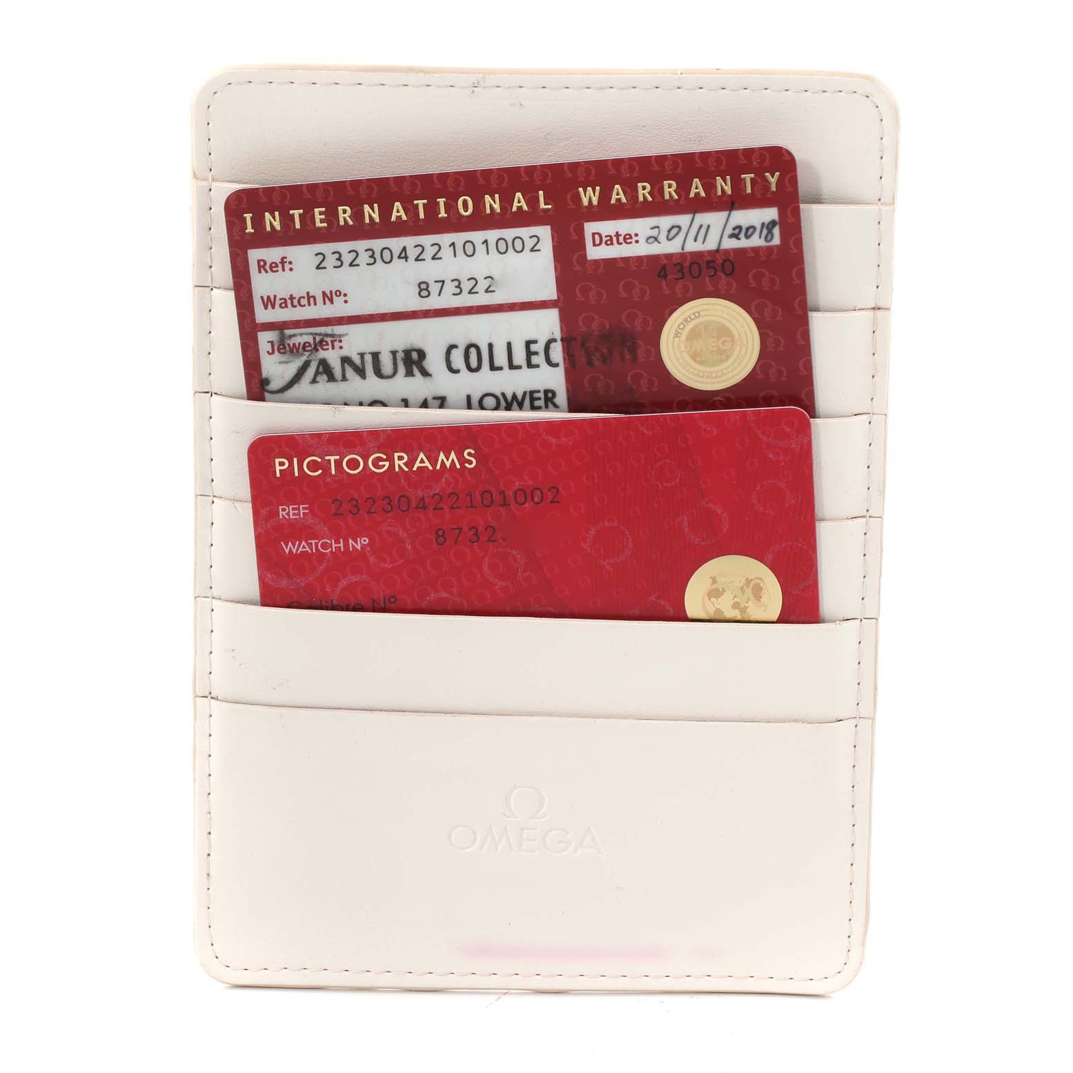 The image shows warranty and pictogram cards in a white Omega cardholder for the Omega Planet Ocean 232.30.42.21.01.002 Men
s Stainless Steel Black Dial 232.30.42.21.01.002 Men
s Stainless Steel Black Dial model watch.