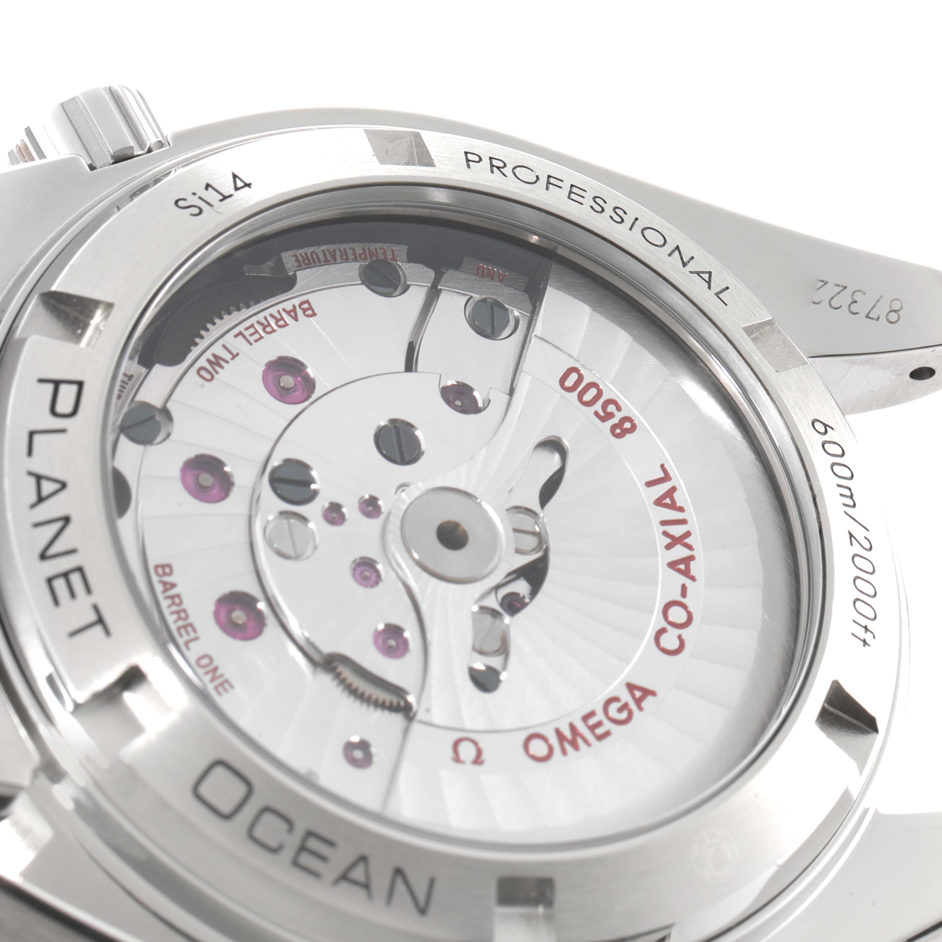 The image shows the back view of the Omega Planet Ocean 232.30.42.21.01.002 Men
s Stainless Steel Black Dial 232.30.42.21.01.002 Men
s Stainless Steel Black Dial watch, revealing the exposed co-axial movement and engravings.