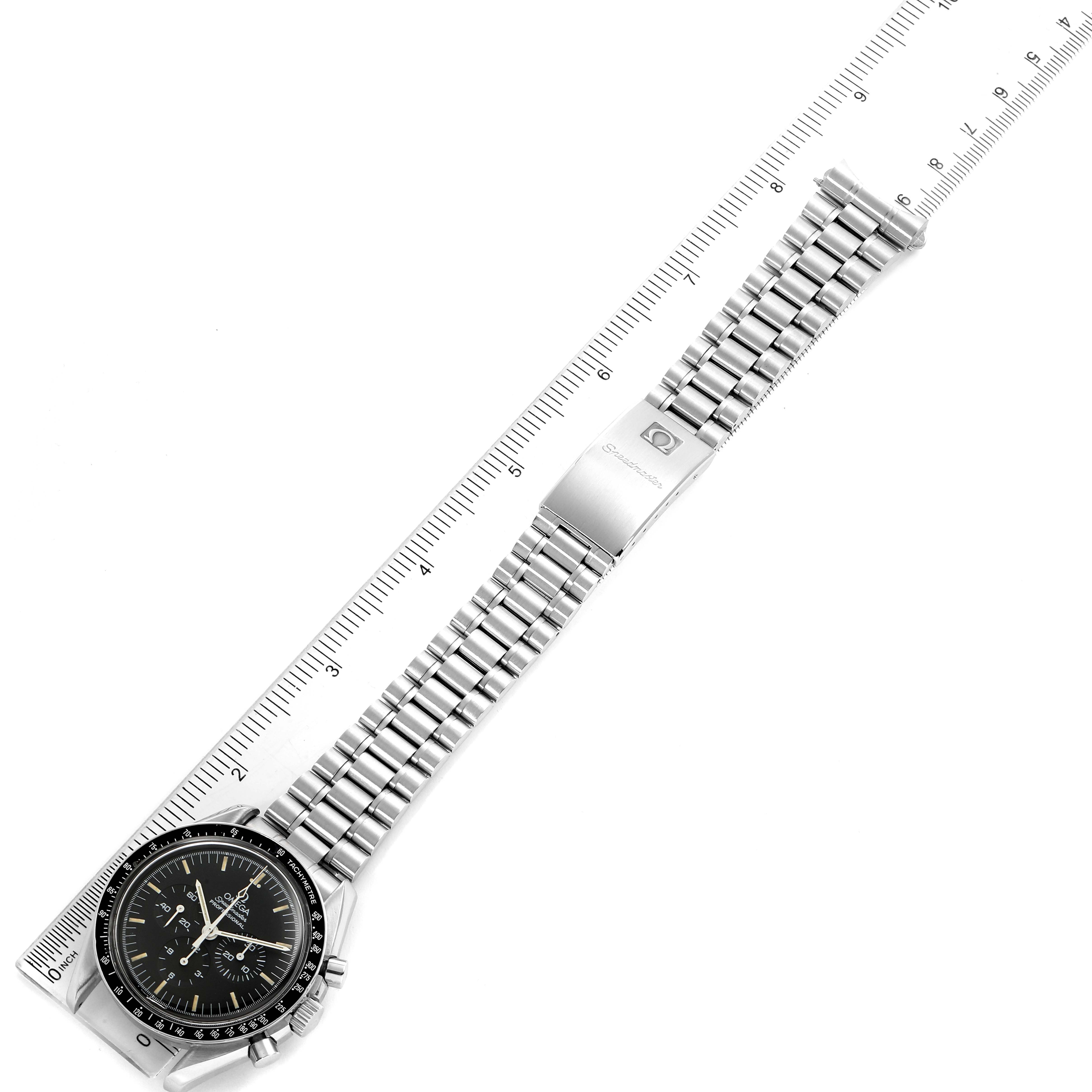The image shows an Omega Speedmaster 3590.50.00 Men's Stainless Steel Black Dial 3590.50.00 Men's Stainless Steel Black Dial watch laid flat with its stainless steel band fully extended alongside a ruler.