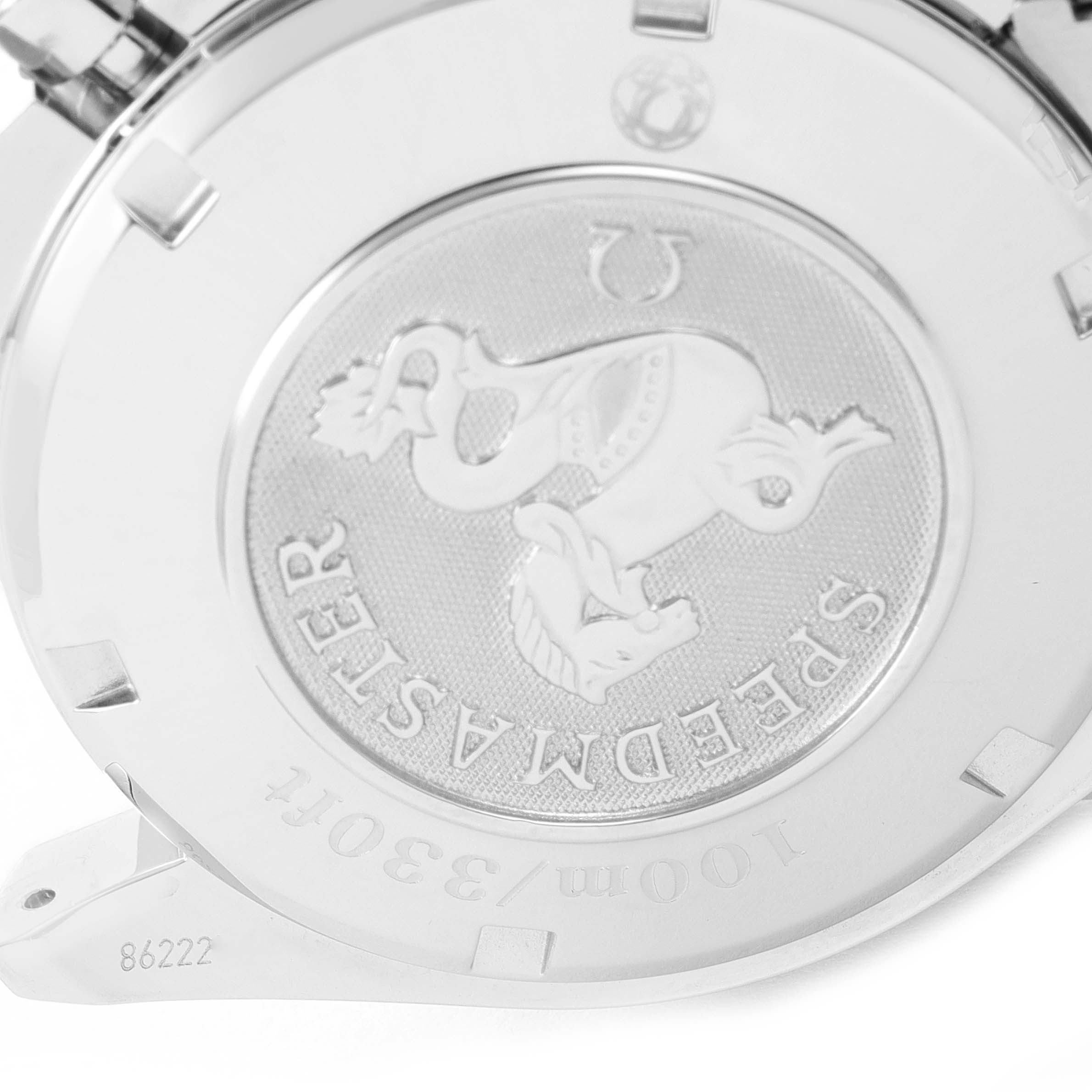 The image shows a close-up of the case back of an Omega Speedmaster 3220.50.00 Men
s Stainless Steel Black Dial 3220.50.00 Men
s Stainless Steel Black Dial watch.