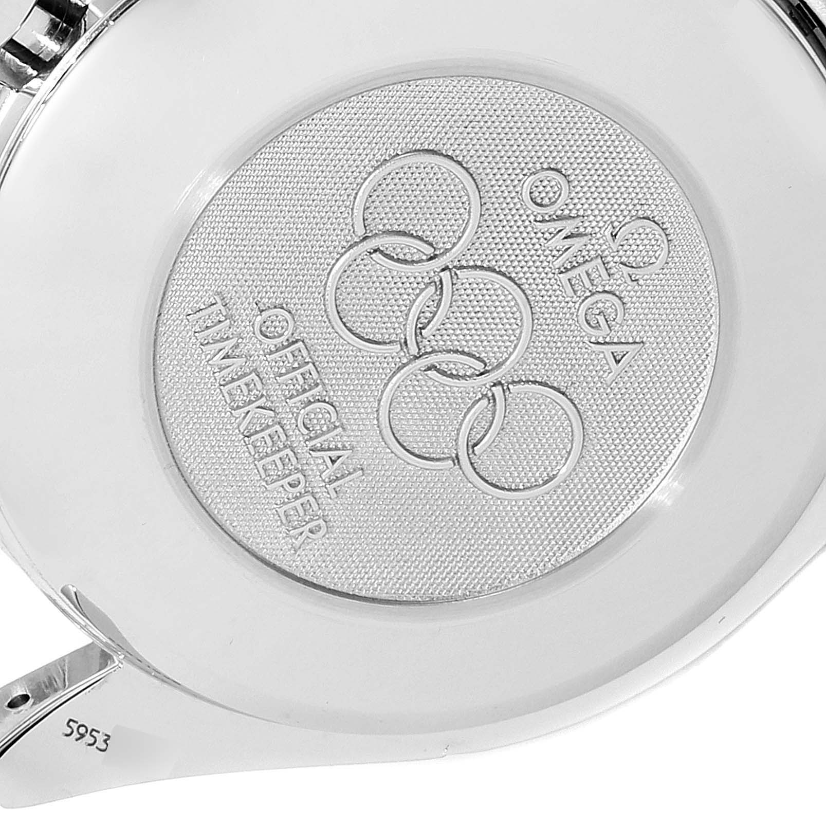 The image shows the back case of an Omega Speedmaster 3515.20.00 Men
s Stainless Steel White Dial 3515.20.00 Men
s Stainless Steel White Dial watch with an engraving of the Olympic rings and "Official Timekeeper."