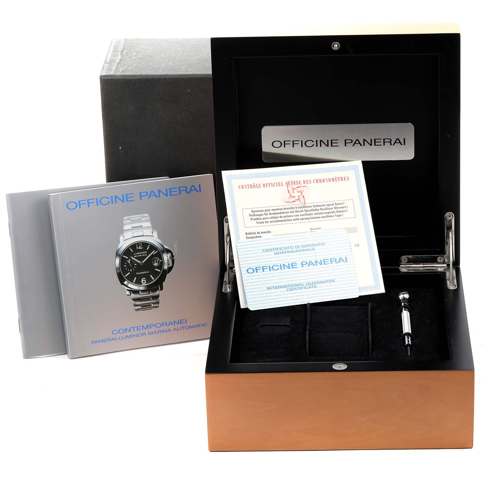 The image shows a Panerai Luminor PAM00104 Men
s Stainless Steel Black Dial PAM00104 Men
s Stainless Steel Black Dial watch box, documentation, and a tool, viewed from the front.