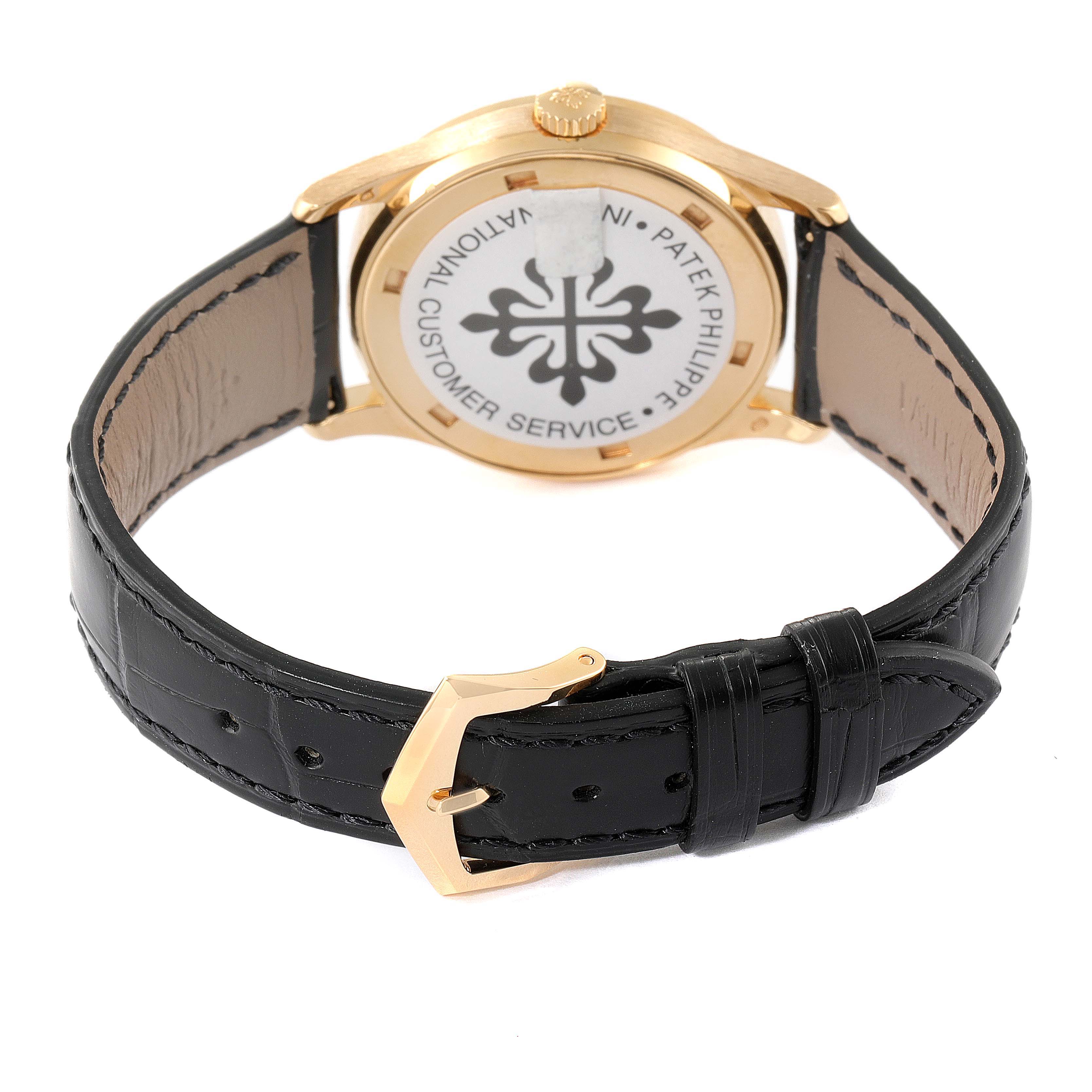 The image shows the back case and black leather strap with gold buckle of a Patek Philippe Calatrava 5096J Men's Yellow Gold Silver Dial 5096J Men's Yellow Gold Silver Dial watch.