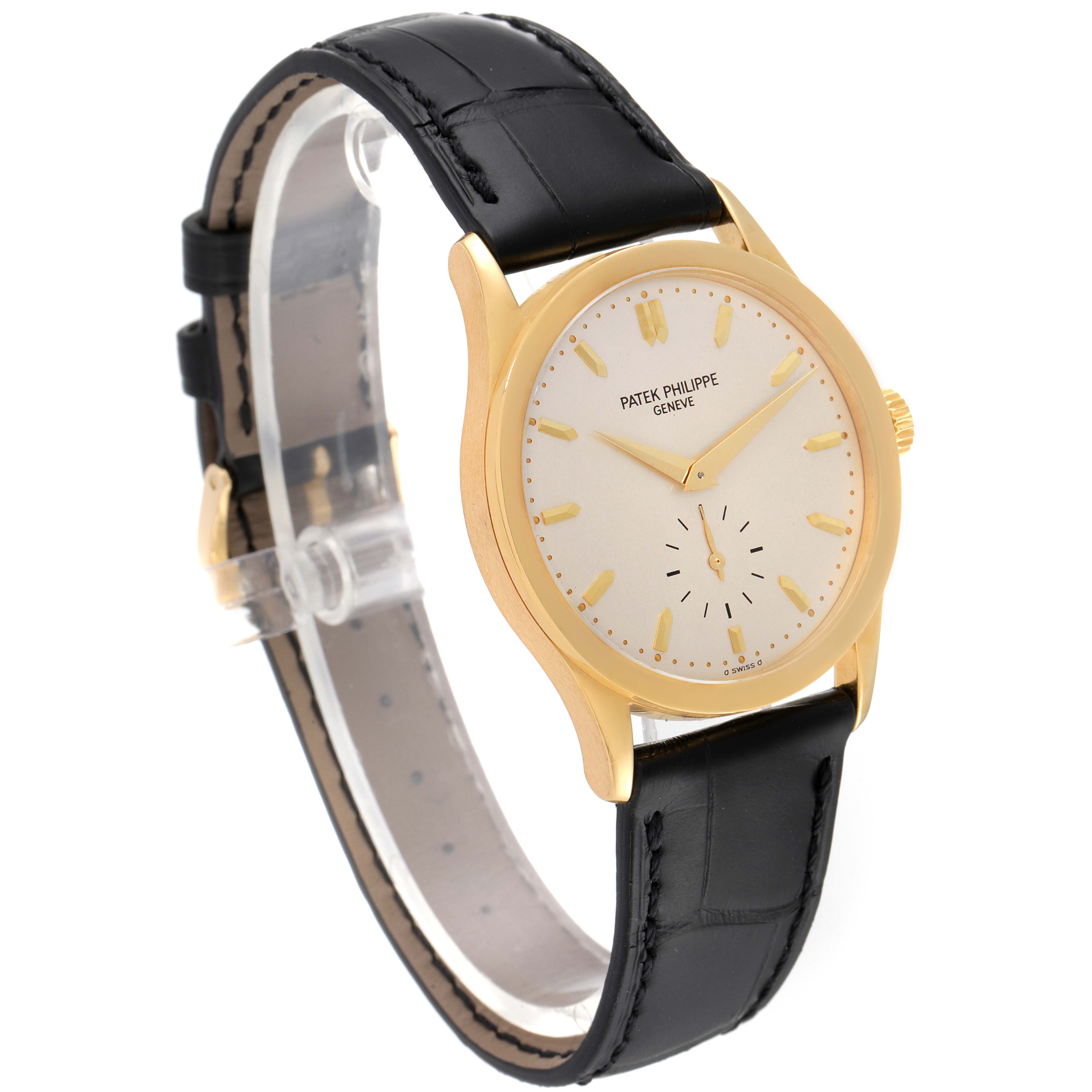 The image shows a Patek Philippe Calatrava 5096J Men's Yellow Gold Silver Dial 5096J Men's Yellow Gold Silver Dial watch at a three-quarter angle, highlighting the face, gold case, and black leather strap.