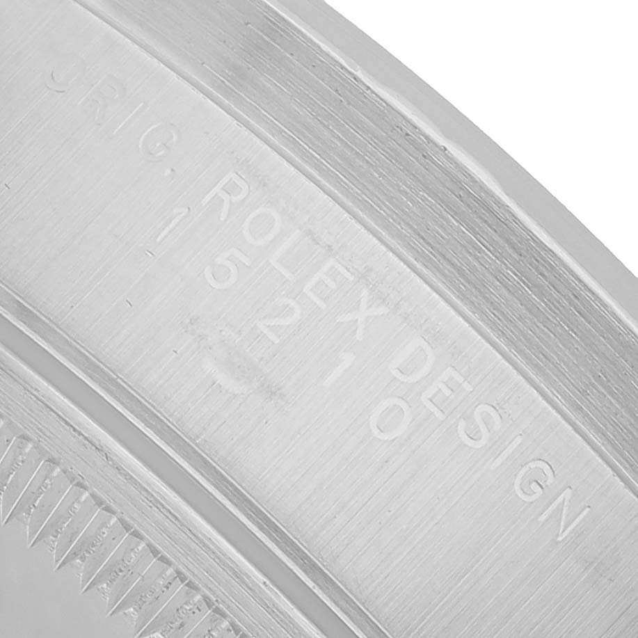 The image shows a close-up of the inner bezel of a Rolex Date 15210 Men's Stainless Steel Silver Dial model, featuring engraved text.