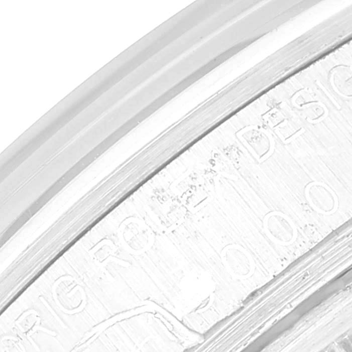 The image shows a close-up of the engraved bezel on a Vintage Collection model by Rolex.
