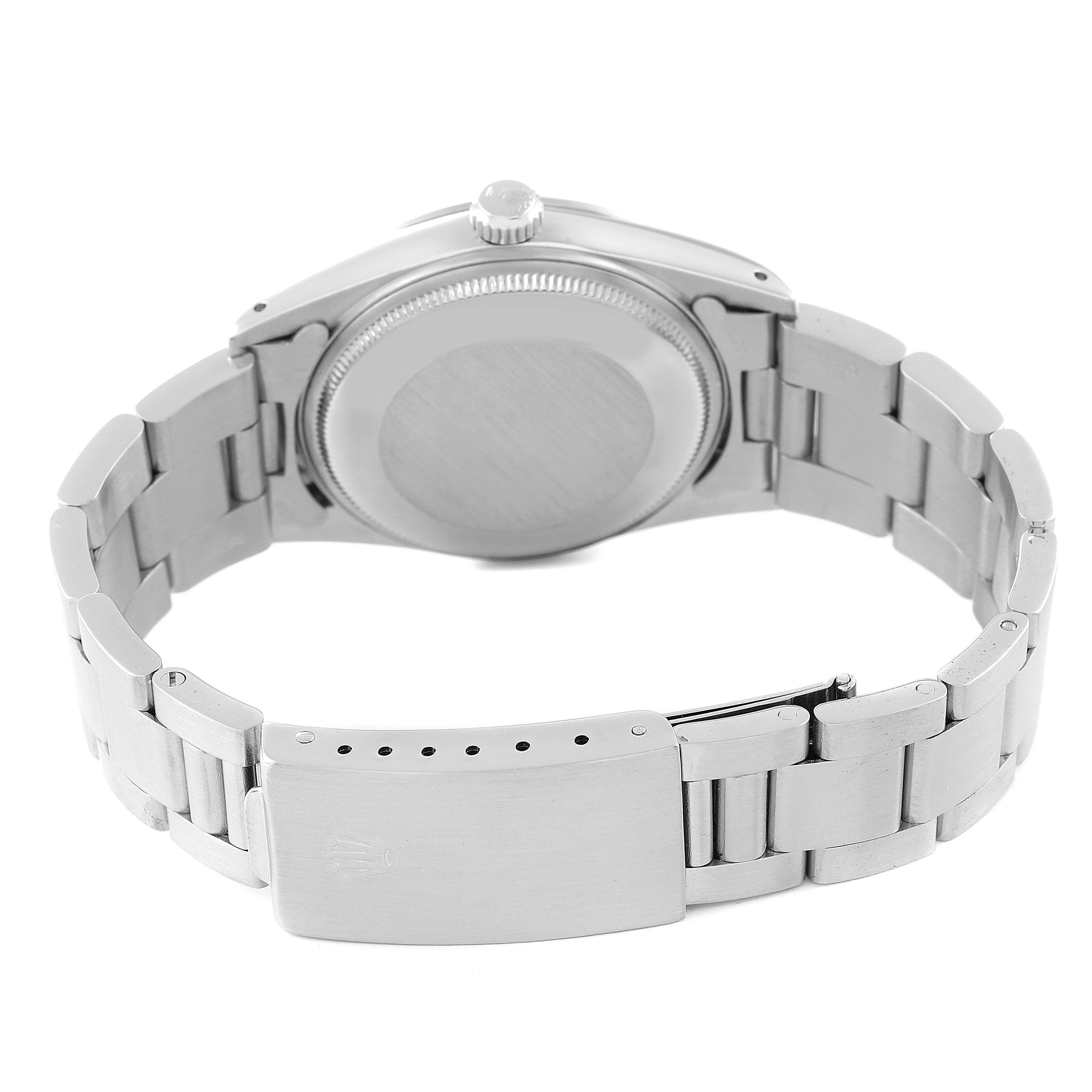 This image shows the Rolex Vintage Collection 15000 Men
s Stainless Steel Silver Dial 15000 Men
s Stainless Steel Silver Dial watch from the back, highlighting its closed metal caseback and bracelet with a clasp.