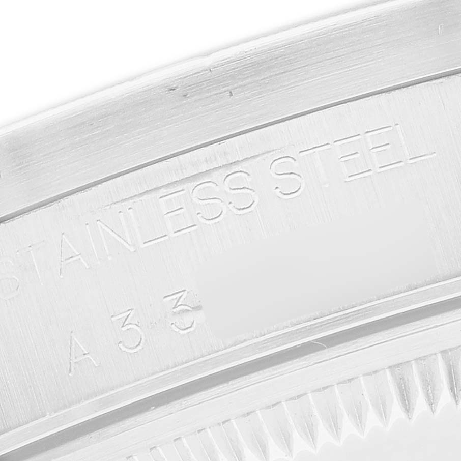 The image shows a close-up of the Rolex Date 15210 Men's Stainless Steel Black Dial model’s stainless steel case back, featuring engraved text.