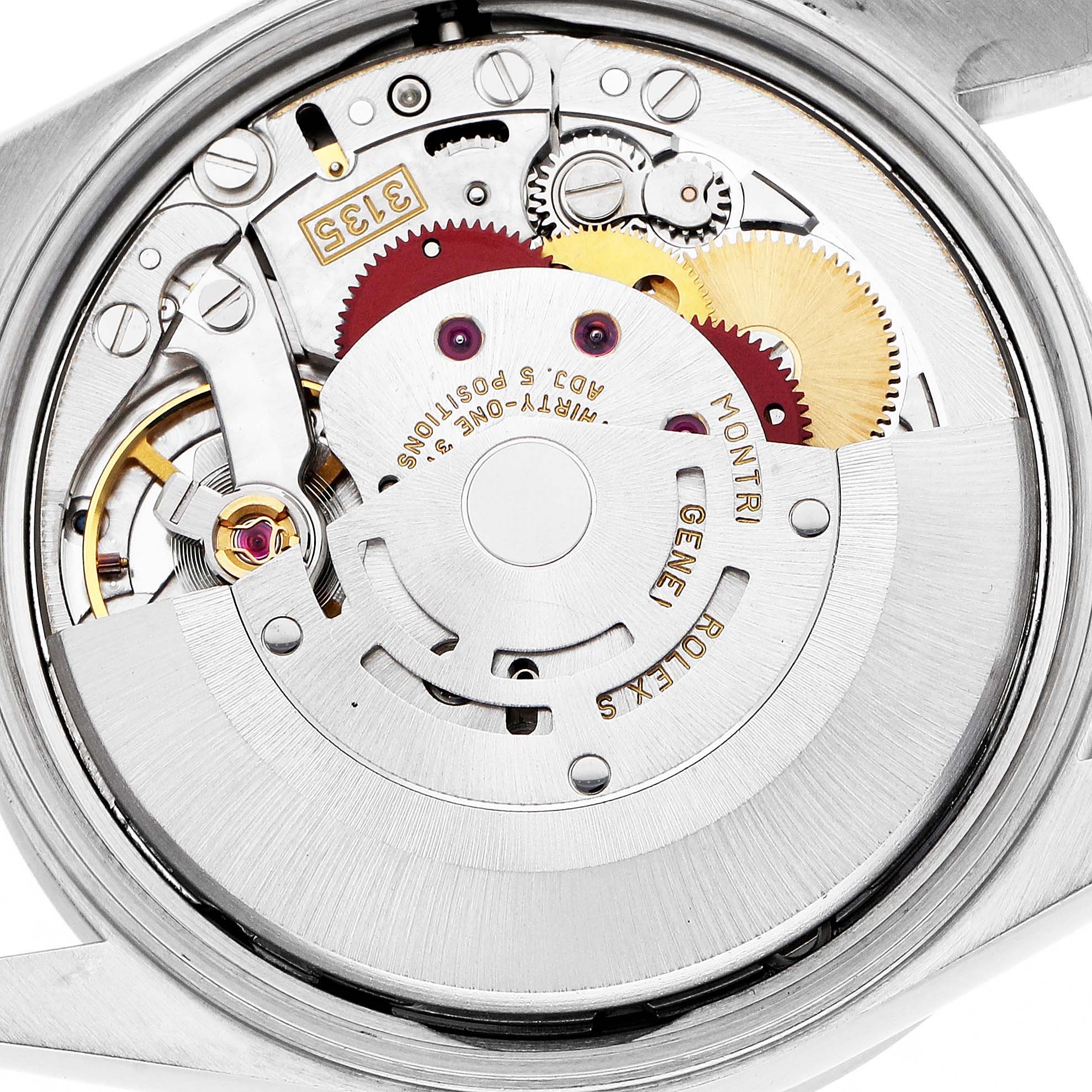 The image shows the movement of a Rolex Date 15210 Men's Stainless Steel Black Dial model watch, highlighting its gears and rotor from a rear angle.