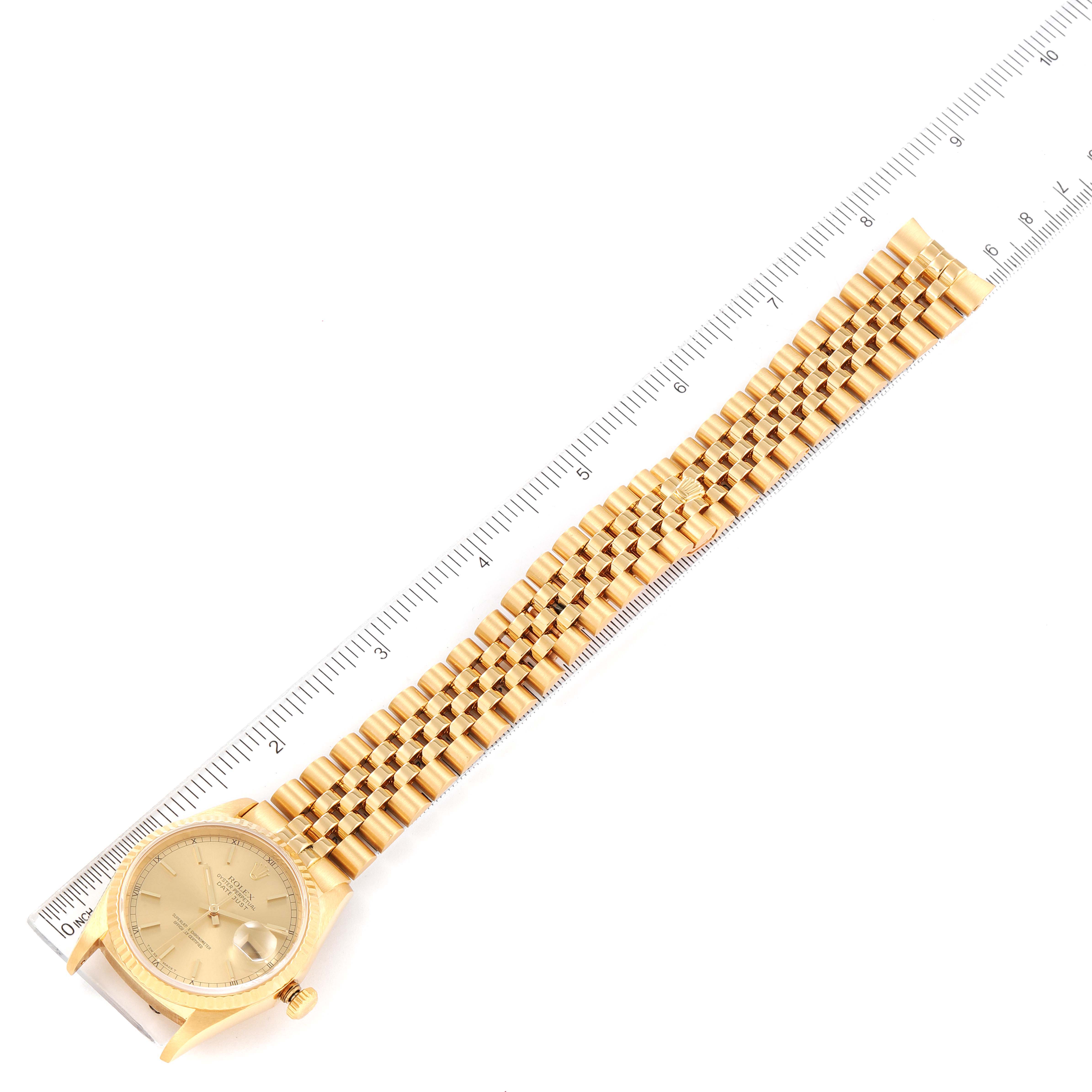 The image shows a top-down view of a Rolex President 16238 Men's Yellow Gold Champagne Dial 16238 Men's Yellow Gold Champagne Dial model watch, including its gold watch face, bezel, and linked bracelet, next to a ruler.