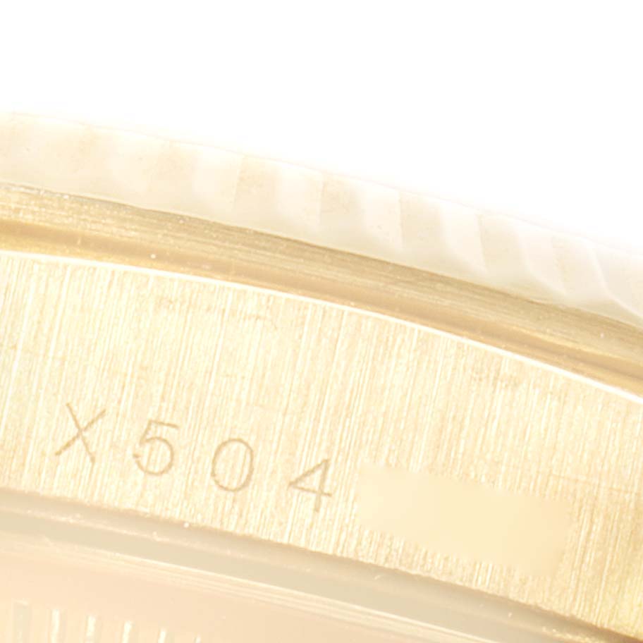 The image shows a close-up of the side of a Rolex President 16238 Men's Yellow Gold Champagne Dial 16238 Men's Yellow Gold Champagne Dial watch, featuring part of its bezel and engraved model number.