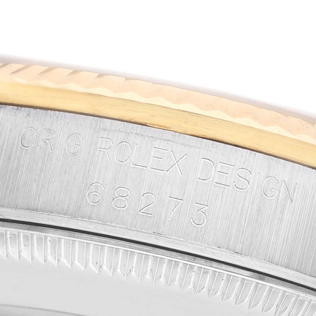 The image shows a close-up of the side engraving on the bezel and case of a Rolex Datejust 68273 Women's Steel and Gold (two tone) White Dial watch.