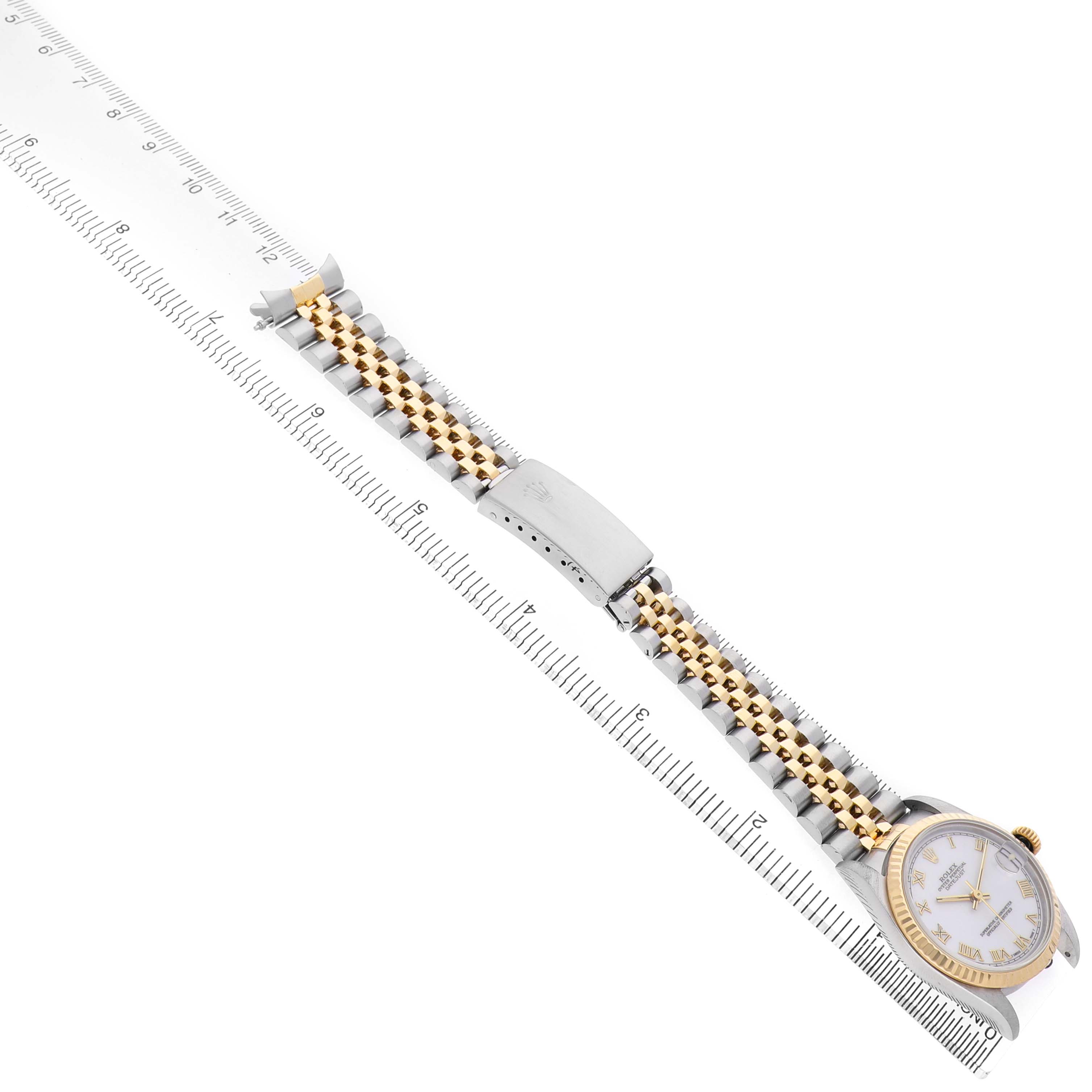 The image shows a Rolex Datejust 68273 Women's Steel and Gold (two tone) White Dial watch laid flat, displaying its bracelet, clasp, and face, alongside a ruler for scale.