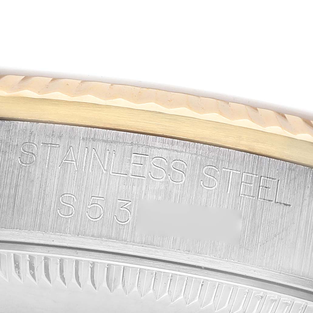 The image shows a close-up of the side of a Rolex Datejust 68273 Women's Steel and Gold (two tone) White Dial watch, highlighting its stainless steel case and engraved markings.