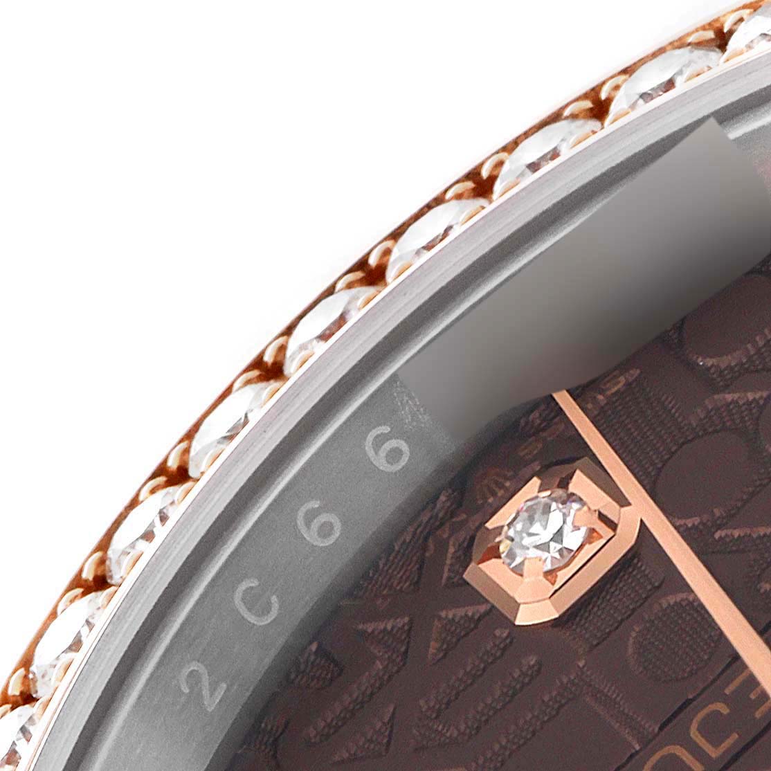 A partial close-up of the bezel and dial of a Rolex Datejust 126281 Men's Steel and Gold (two tone) Brown Dial 126281 Men's Steel and Gold (two tone) Brown Dial watch, showcasing diamonds and the engraved numerals.