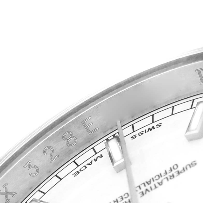 The image shows a close-up of the bezel and partial dial of a Rolex Datejust 116234 Men's Stainless Steel White Dial, highlighting the markings and hour markers.