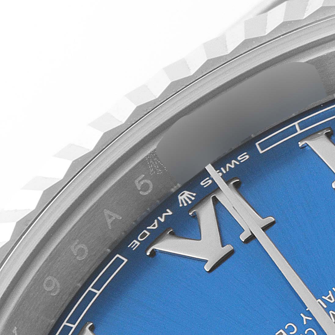 This close-up shows the bezel, part of the dial with Roman numerals, and the "Rolex" logo on the Datejust 41 model by Rolex.