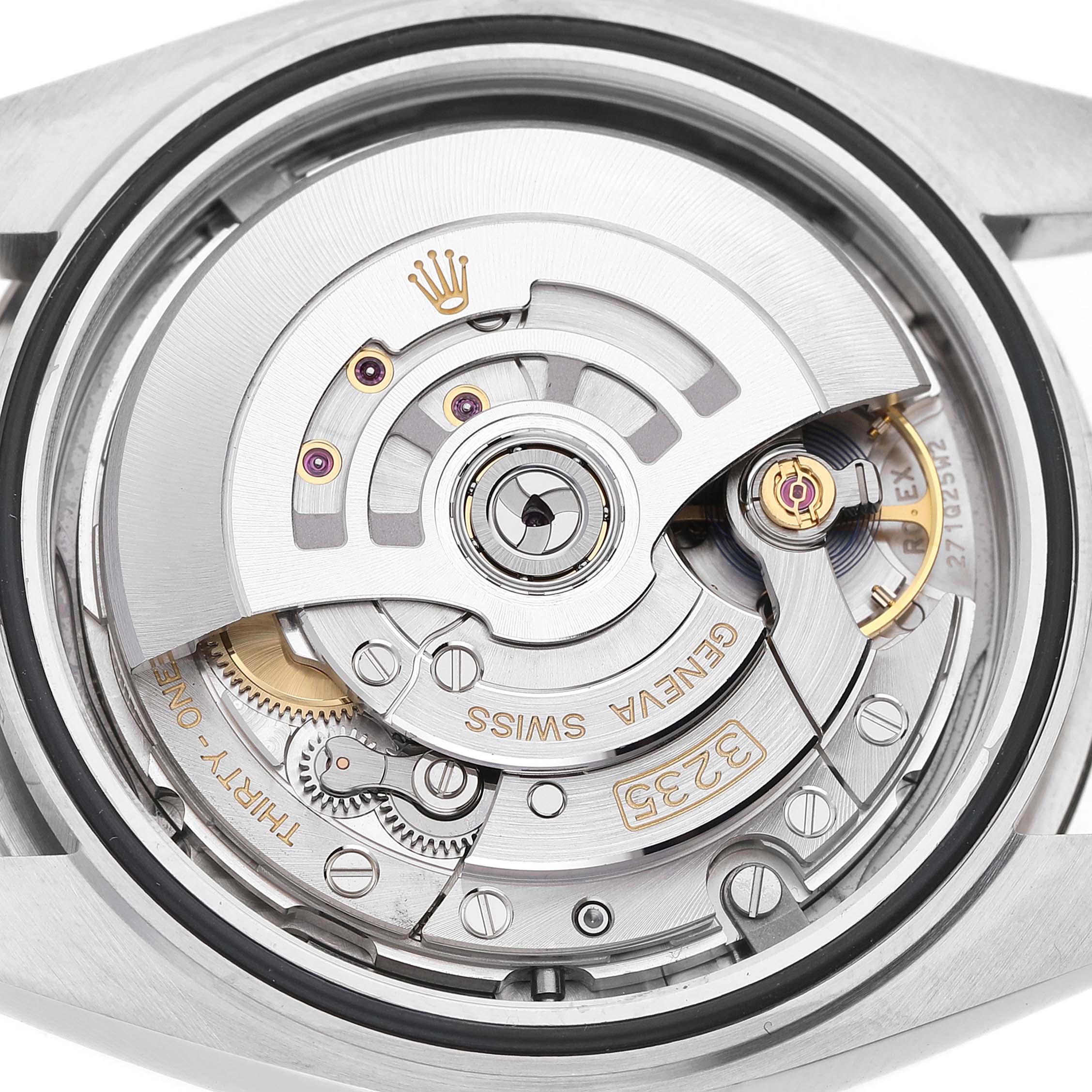 The image shows the inner movement of a Rolex Datejust 41 126334 Men's Stainless Steel Blue Dial watch from a back view, highlighting the rotor and gears.