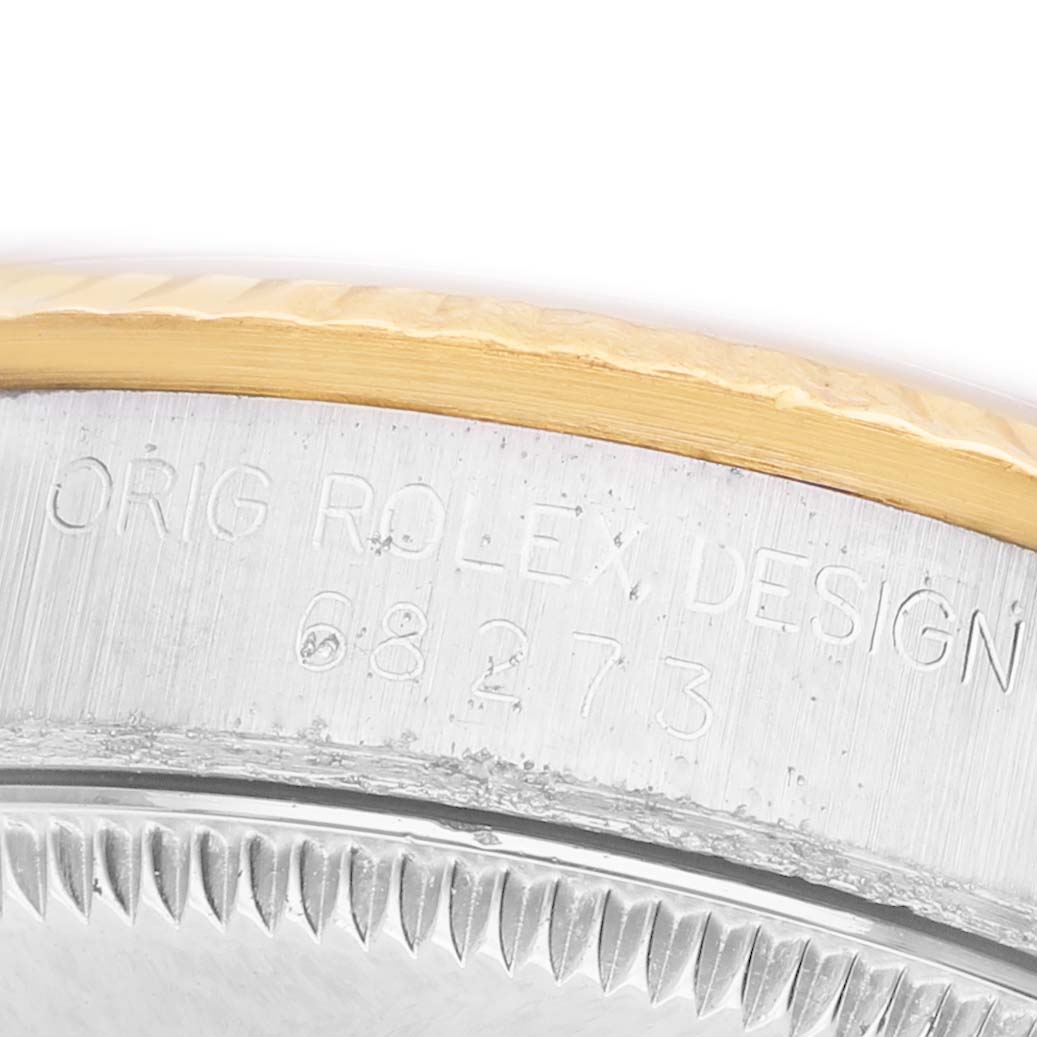 The image shows a close-up of the case edge and bezel of the Rolex Datejust 68273 Women's Steel and Gold (two tone) Champagne Dial, displaying engraved details.
