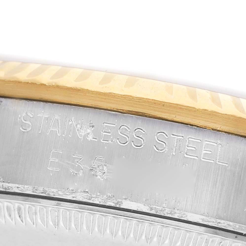 The image shows a close-up side view of the bezel and case edge of a Rolex Datejust 68273 Women's Steel and Gold (two tone) Champagne Dial, highlighting "Stainless Steel" engraving.