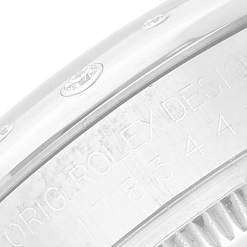 The image shows a close-up angle of the watch bezel and inscribed inner case of a Mid-Size Rolex model.
