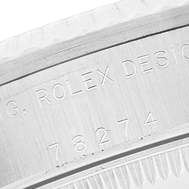 This close-up image shows the engraved inner bezel of a Mid-Size Rolex watch model, highlighting the design number and brand mark.