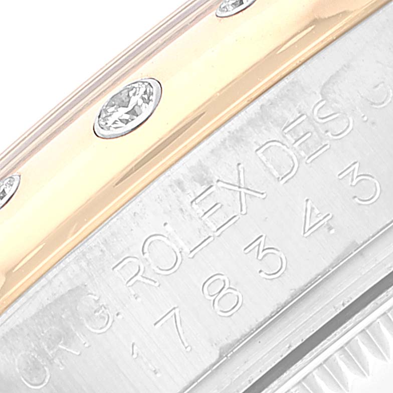 This image shows a close-up of the bezel and engraved side of a Rolex Mid-Size 178343 Women
s Steel and Gold (two tone) Grey Dial 178343 Women
s Steel and Gold (two tone) Grey Dial watch, featuring diamond accents.