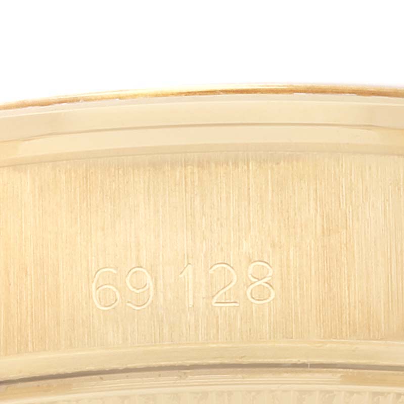 This image shows a close-up of the case or bracelet of the Rolex President 69128 Women
s Yellow Gold Champagne Dial 69128 Women
s Yellow Gold Champagne Dial model, displaying the reference number "69128".