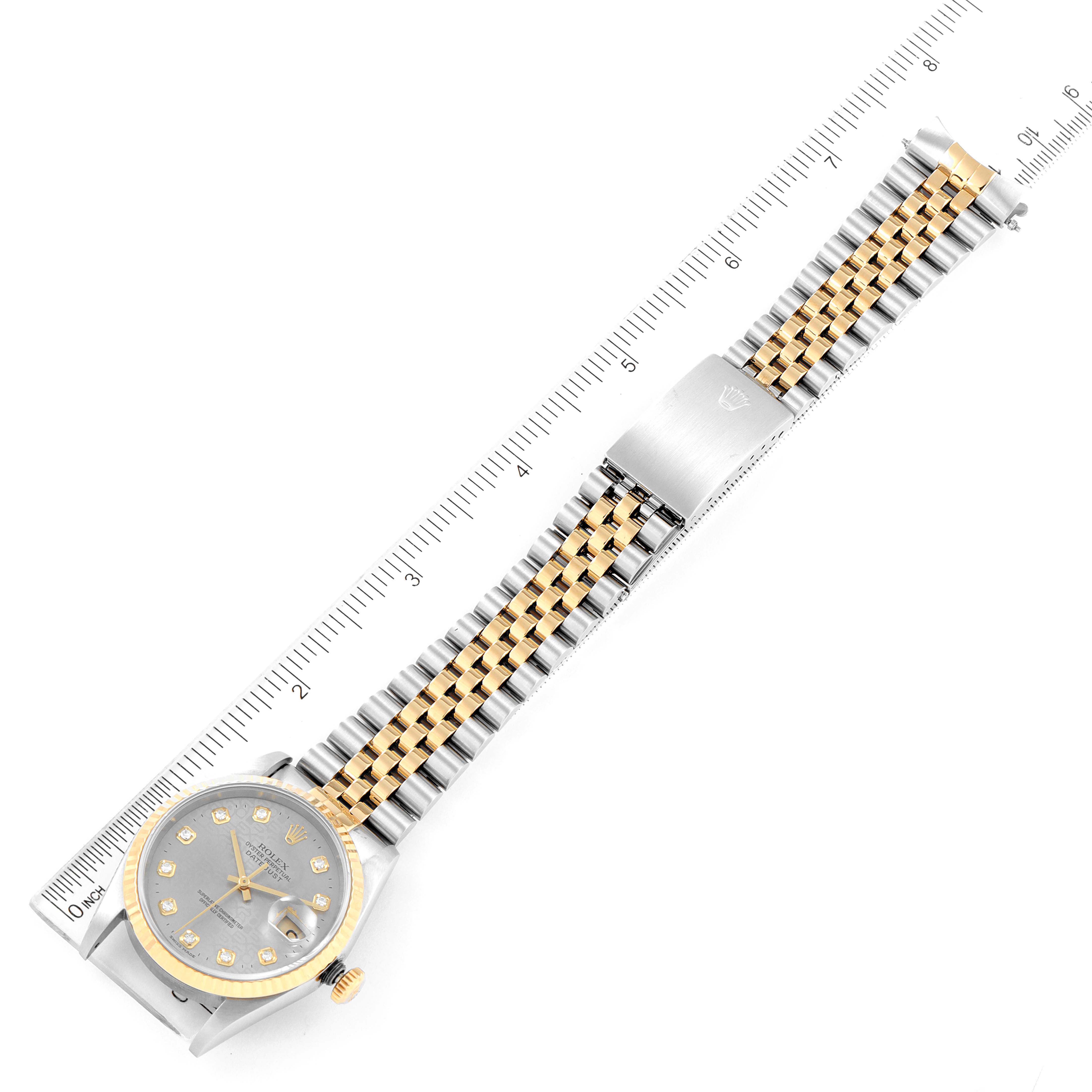 This image shows a Rolex Datejust 16233 Men
s Steel and Gold (two tone) Grey Dial 16233 Men
s Steel and Gold (two tone) Grey Dial watch laid flat, with the face, band, and clasp visible against a ruler for scale.