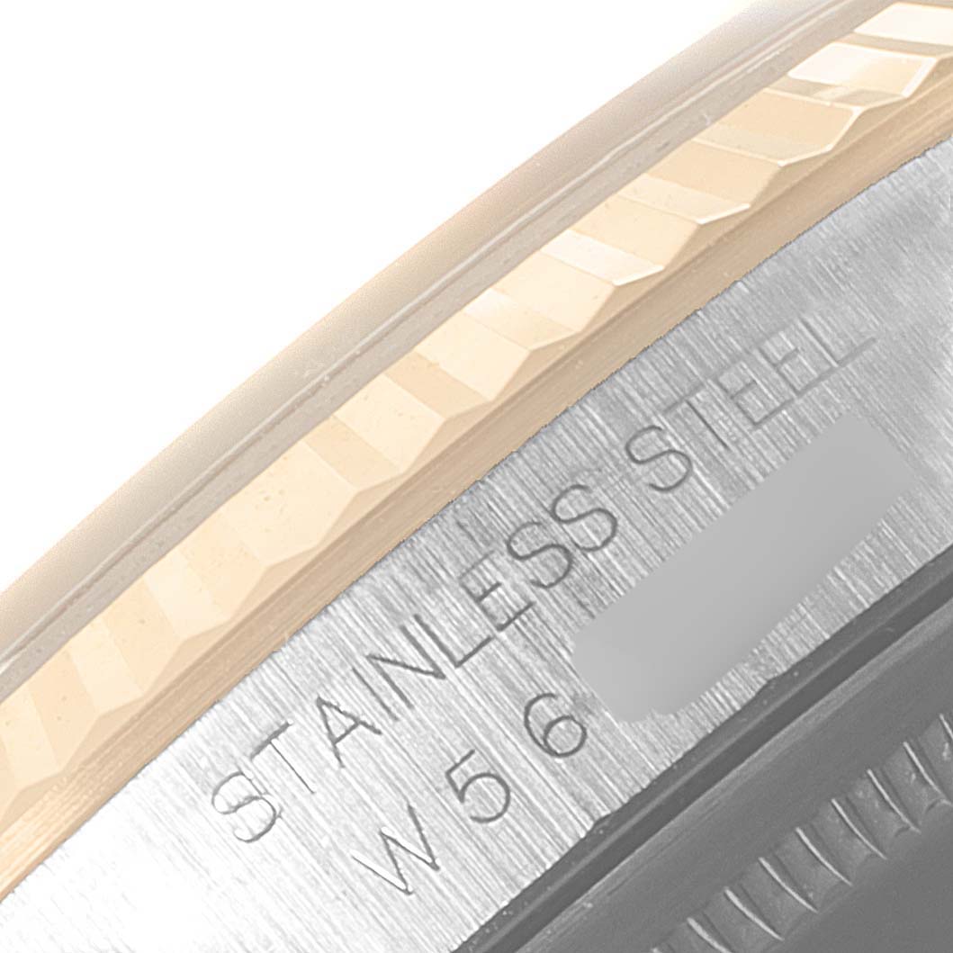 This close-up of the Rolex Datejust 16233 Men
s Steel and Gold (two tone) Grey Dial 16233 Men
s Steel and Gold (two tone) Grey Dial watch shows the bezel and part of the case with "STAINLESS STEEL" engraving.