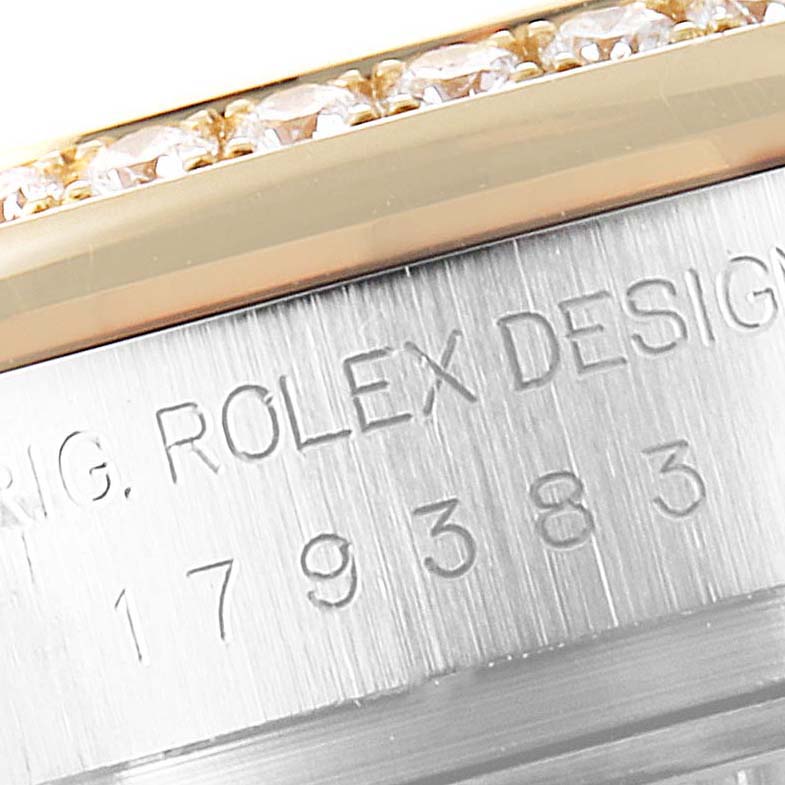 This image shows a close-up of the engraved side of a Rolex Datejust 179383 Women
s Steel and Gold (two tone) Silver Dial 179383 Women
s Steel and Gold (two tone) Silver Dial watch, highlighting the serial number and part of the bezel.