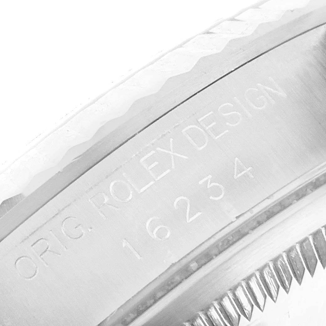 This image shows a close-up of the serial number engraving on the case of a Rolex Datejust 16234 Men's Stainless Steel Black Dial 16234 Men's Stainless Steel Black Dial watch.