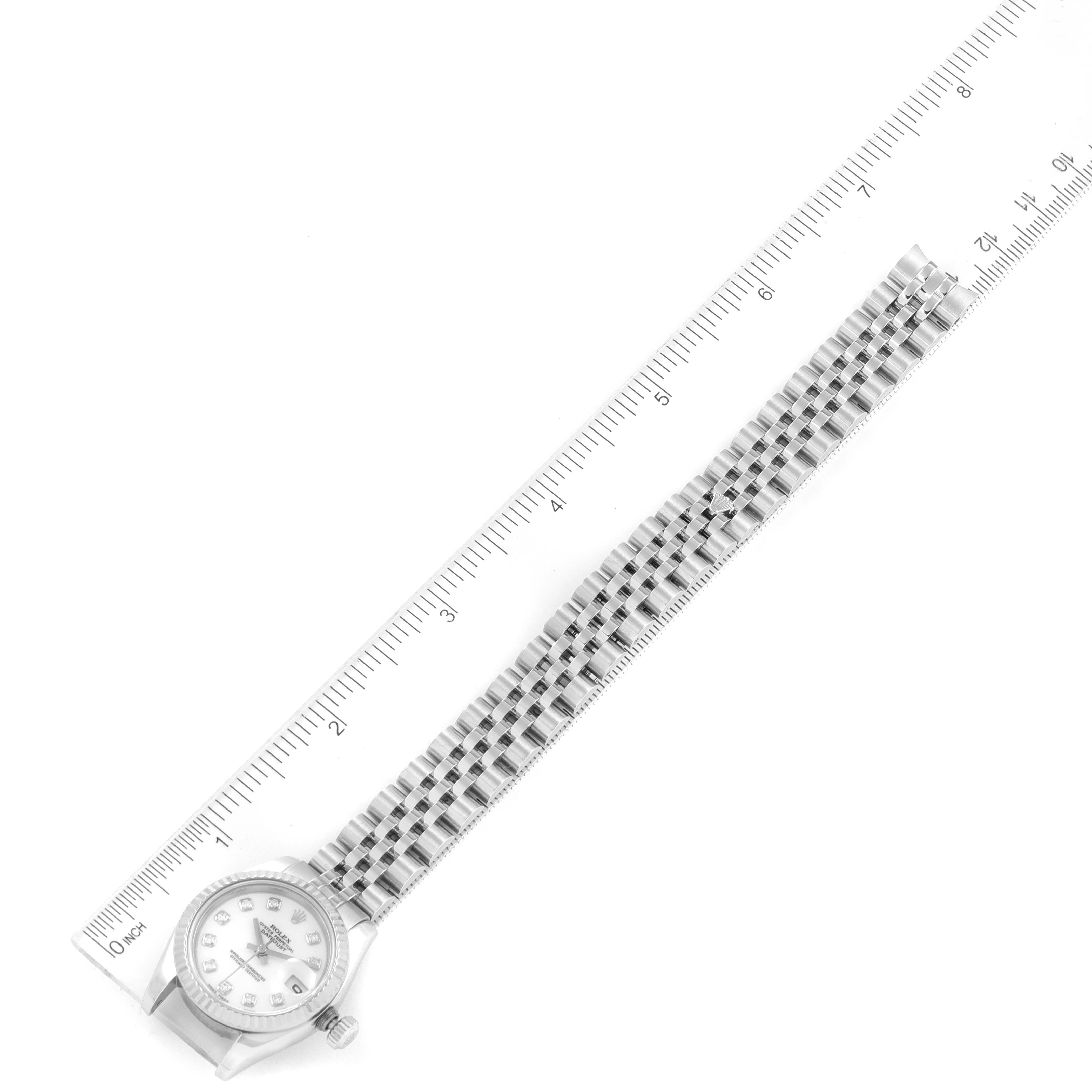 The image shows a Rolex Datejust 179174 Women's Stainless Steel White Dial 179174 Women's Stainless Steel White Dial watch including its face and band, angled alongside a ruler for measurement.