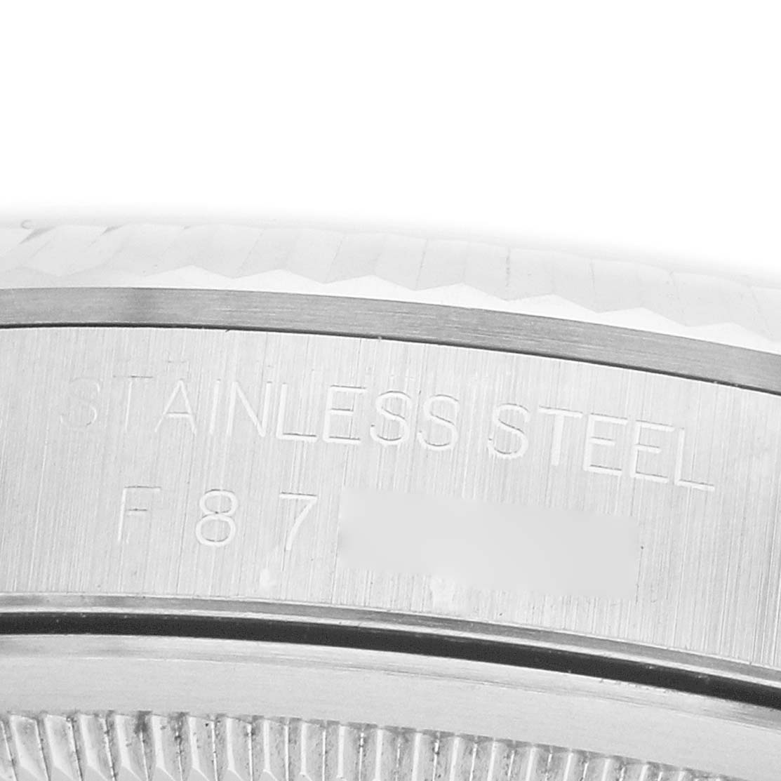 The image shows a close-up of the side detailing and engravings on the bezel of a Rolex Datejust 16234 Men's Stainless Steel Silver Dial watch.
