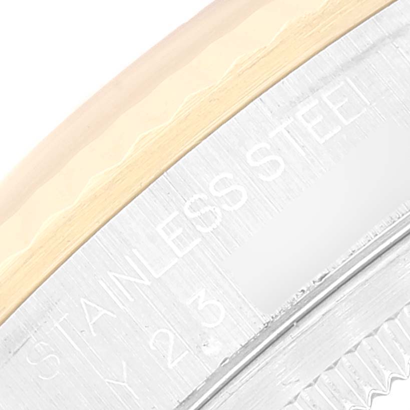 This close-up image of a Rolex Datejust 16233 Men's Steel and Gold (two tone) Champagne Dial 16233 Men's Steel and Gold (two tone) Champagne Dial watch shows part of the stainless steel case and the fluted bezel.