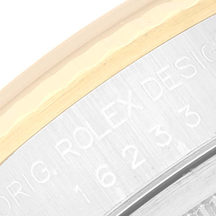 This close-up image shows the engraved edge of the bezel of a Rolex Datejust 16233 Men's Steel and Gold (two tone) Champagne Dial 16233 Men's Steel and Gold (two tone) Champagne Dial watch.